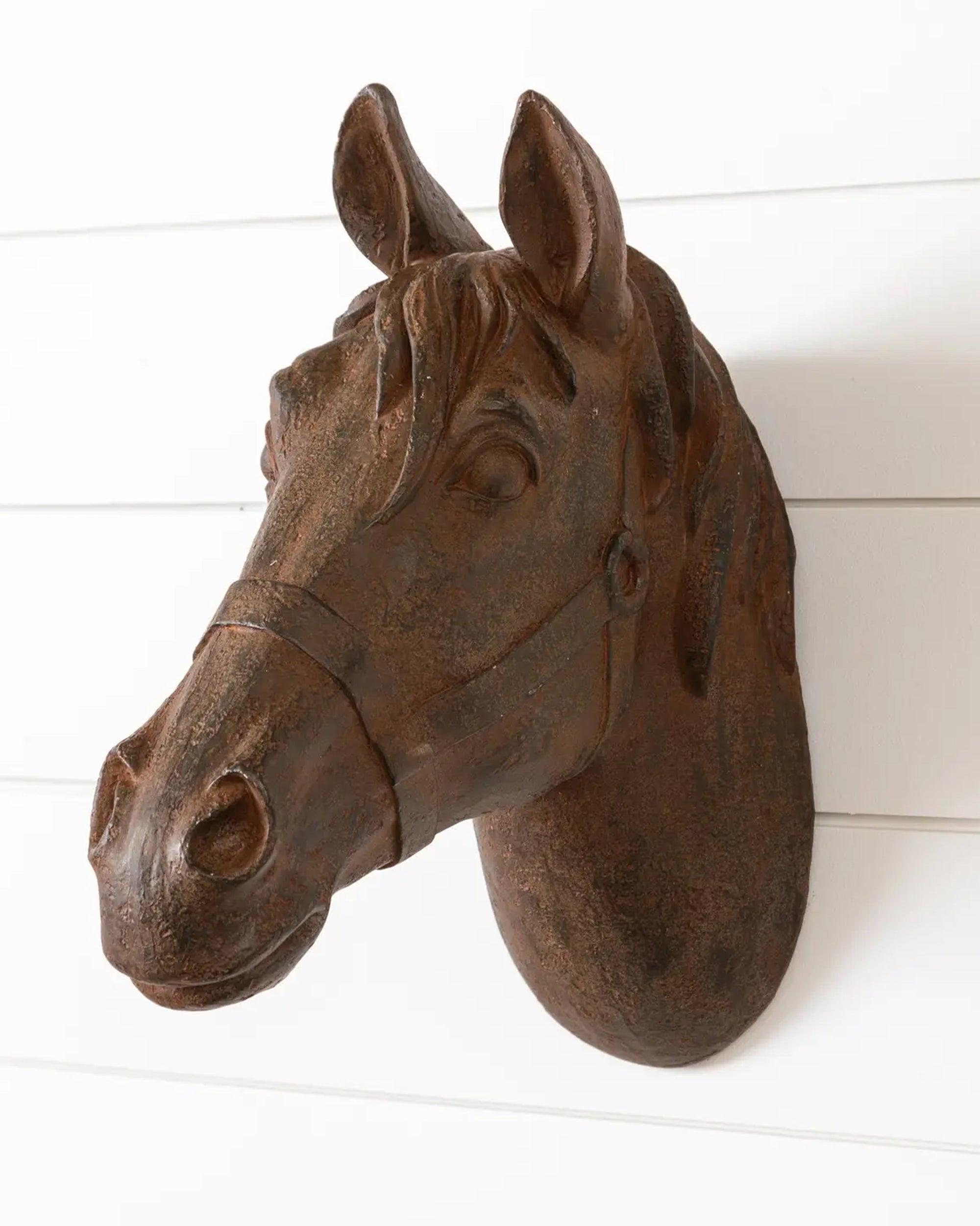 The Faire Horse Head Wall Mount features a brown, textured polyresin sculpture, displayed on a white shiplap wall and shown from the front.