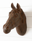 The Faire Horse Head Wall Mount features a brown, textured polyresin sculpture, displayed on a white shiplap wall and shown from the front.