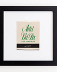 A framed vintage matchbook cover from Hotel Bi-Rin in Los Angeles displayed on a white wall, featuring elegant green script on an acrylic background in an Art Square Black Frame by Match South.