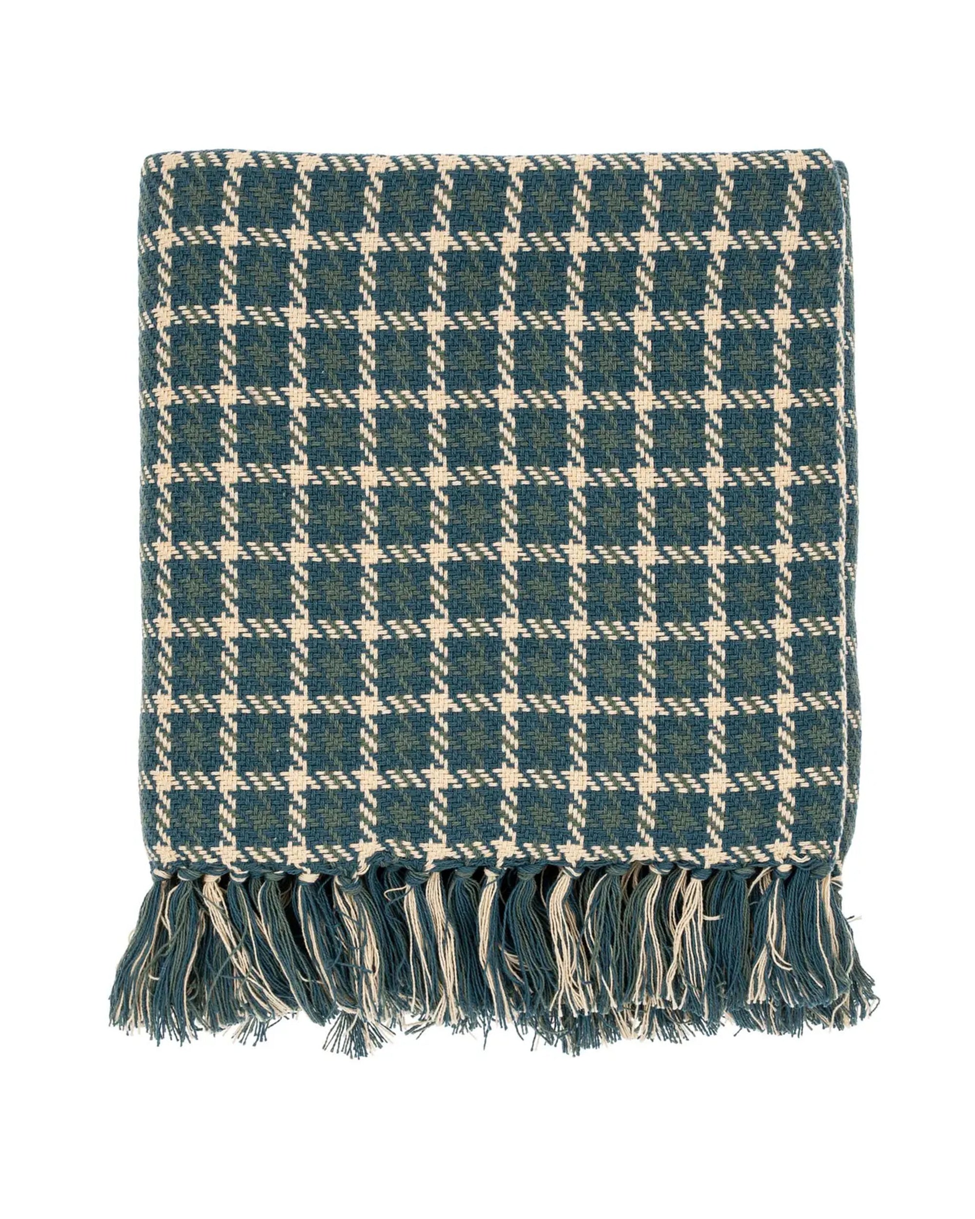 The Indaba Houndstooth Throw in Teal is a soft Indian cotton blanket with a blue and white pattern and textured fringe tassels along the bottom edge, shown folded on a white background.