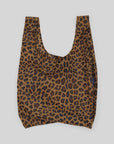 The Baggu Standard by Baggu is a chic, machine-washable reusable shopping bag made from recycled ripstop nylon. It features a leopard print on a plain gray background and has a wide opening with short handles for convenience.