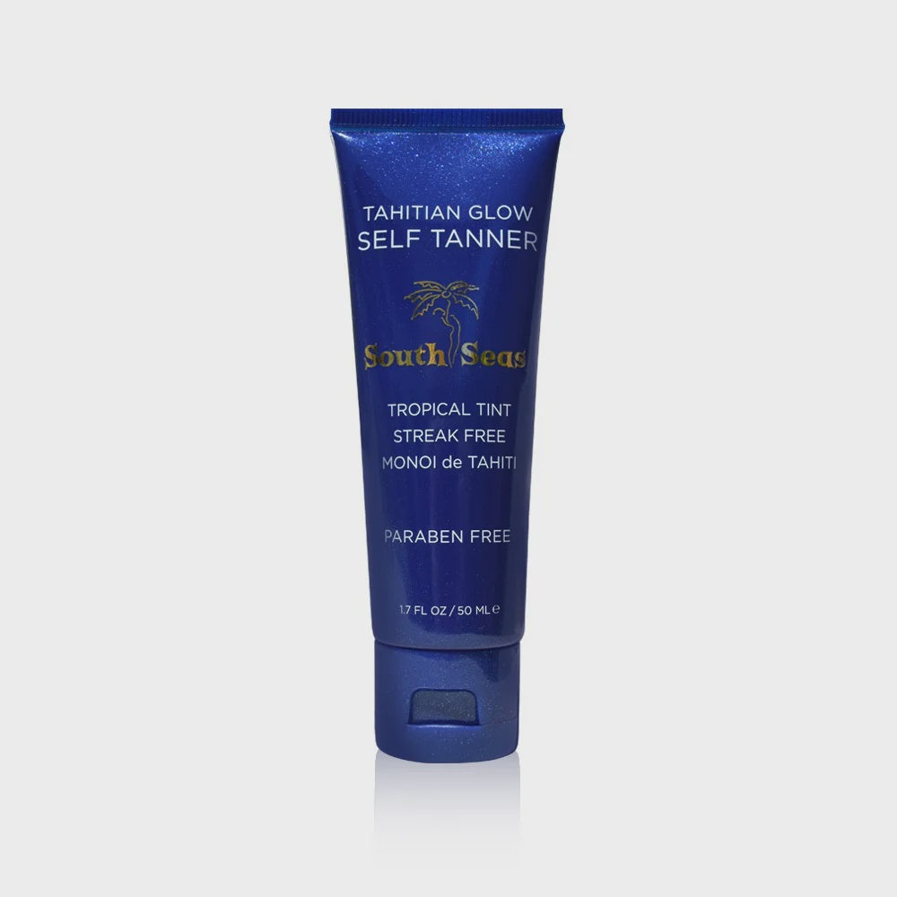 A blue tube of South Seas Skincare's Mini Tahitian Glow Self Tanner offers a tropical tan with its streak-free formula. Enriched with organic DHA and Monoi de Tahiti, it's paraben-free, adorned with a palm tree design, and contains 1.7 fl oz (50 ml).