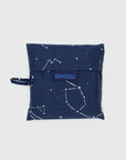 The Baggu Standard is a square pouch in dark blue, made from recycled ripstop nylon featuring a constellation design and side handle. "BAGGU" is printed on the center flap in blue. This reusable, machine-washable bag is displayed against a light gray background for easy care.