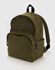 The Baggu Nylon Backpack in olive green is made from recycled nylon and features a large main compartment, front zippered pocket, adjustable padded shoulder straps, and a black top carrying handle with a small blue tag on the side.