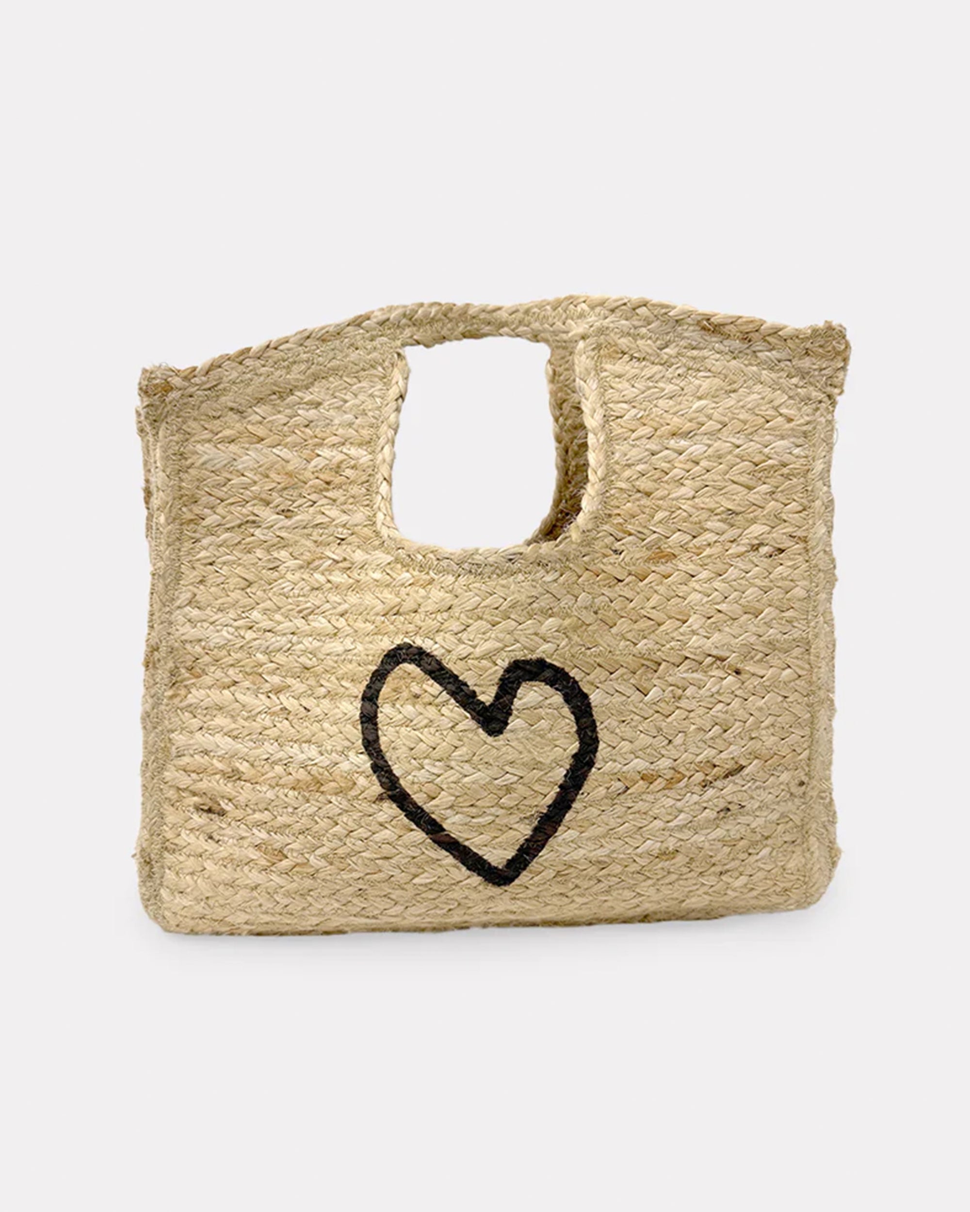 The Imperfect Heart Jute Tote by Kerri Rosenthal is a rectangular handmade bag crafted from natural jute, with a built-in handle and a black imperfect heart on the front, shown on a plain white background.