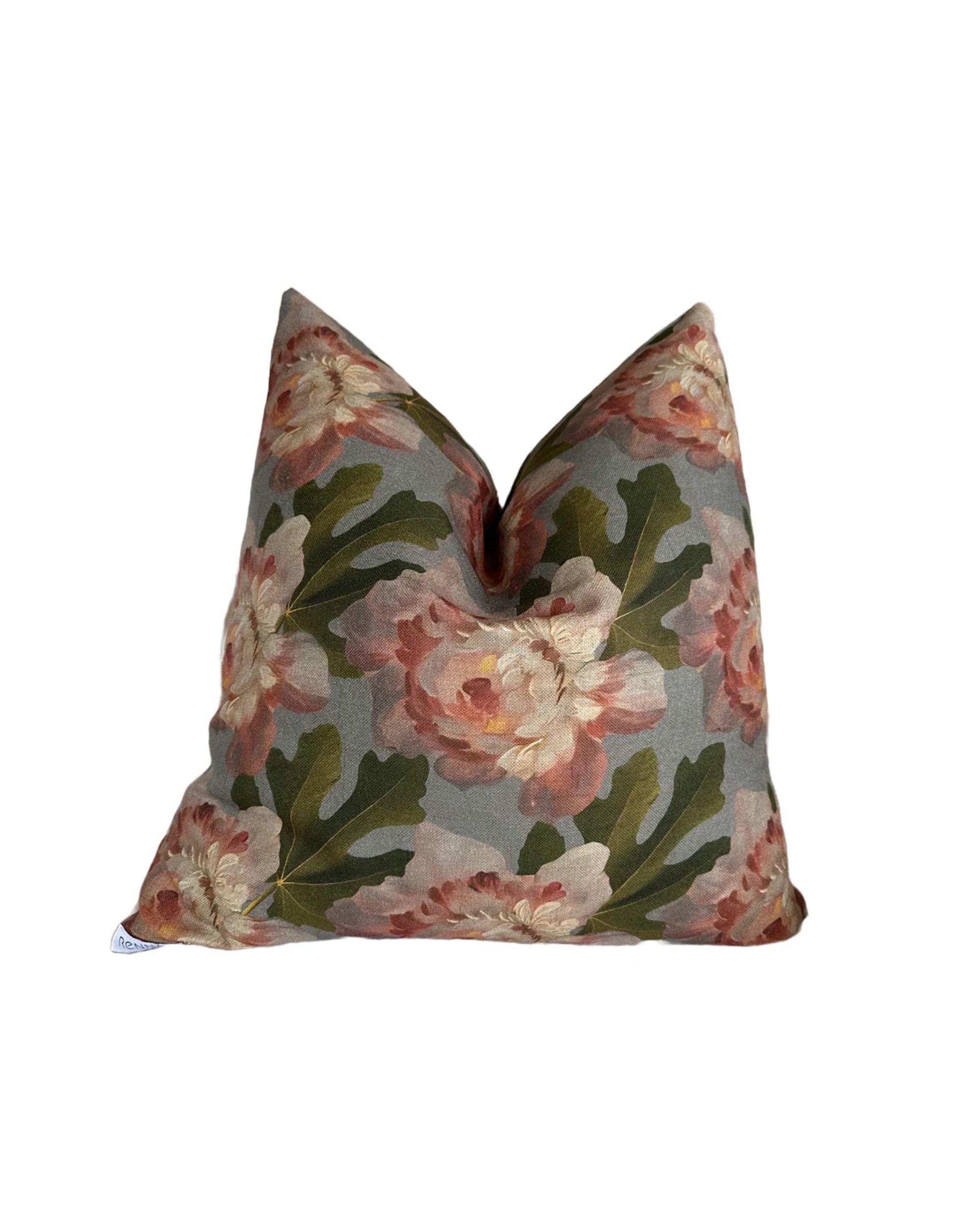 The Rennah Collective Iris Pillow 22x22 is a square woven pillow with large pink and cream floral designs on muted gray, made of a polyester-linen blend. It has a plush look, subtle center crease, and is machine washable for easy care.