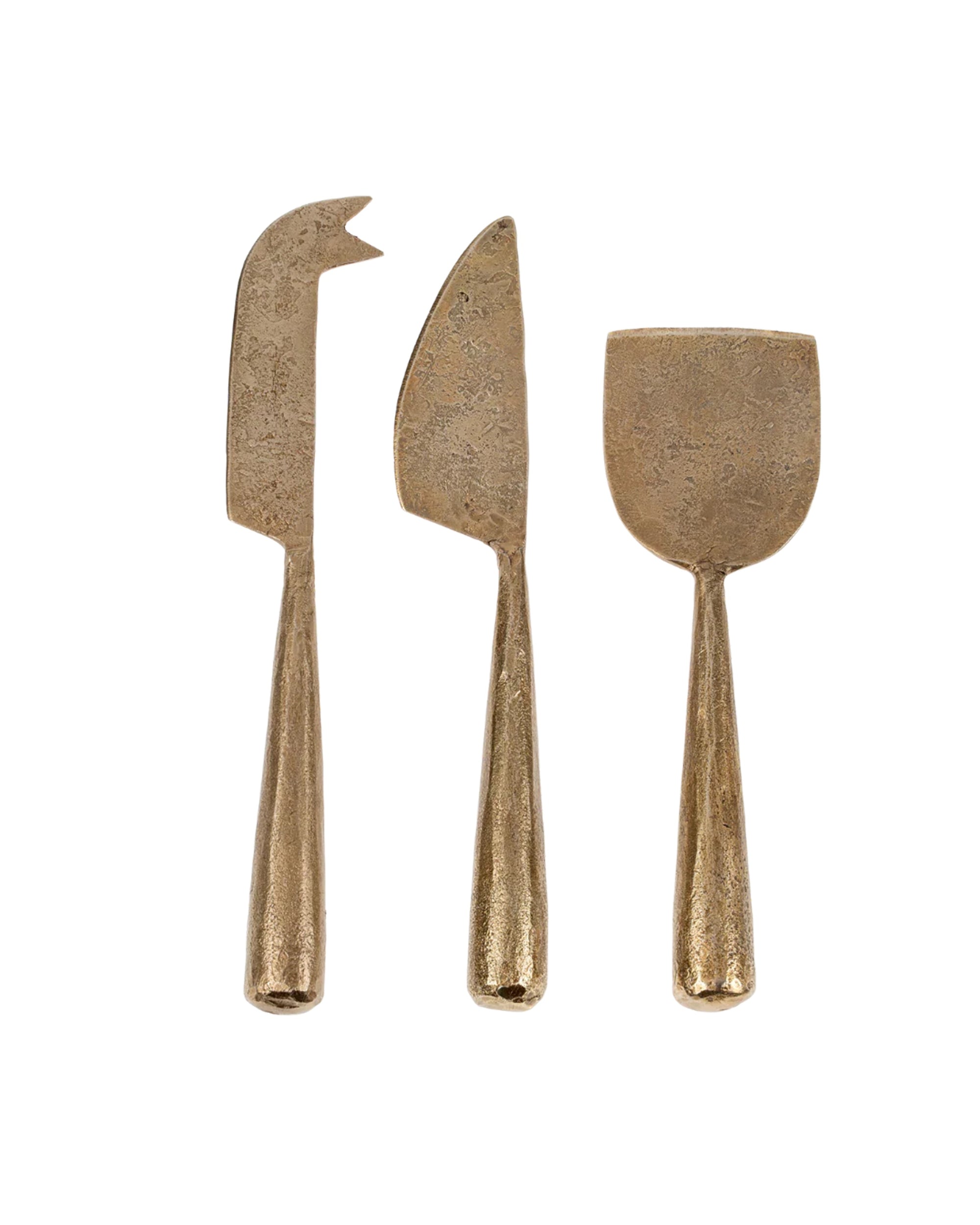 The Indaba 4-7098 Cheese Knives S/3 includes three brass cheese knives with textured handles and uniquely shaped blades for slicing, spreading, and serving cheese, all hand forged to highlight fine metal craftsmanship.
