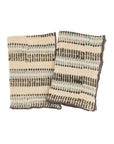 Two folded Ishita Block Print Tea Towels by Indaba, cream-colored with horizontal black and blue dotted stripes, are displayed side by side on a plain white background.
