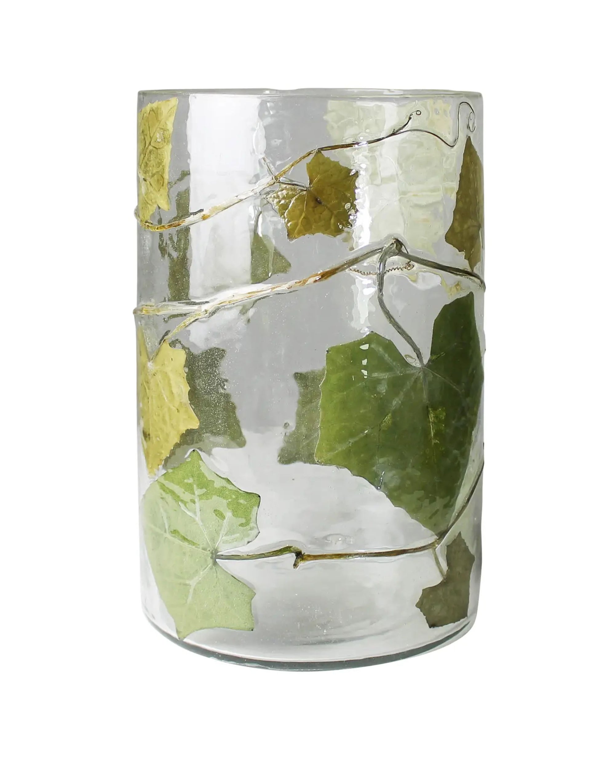 The HomArt Enameled Hurricane / Ivy clear glass tumbler features green and yellow vine leaves with winding stems, evoking the look of an ivy enameled glass garden luminary.