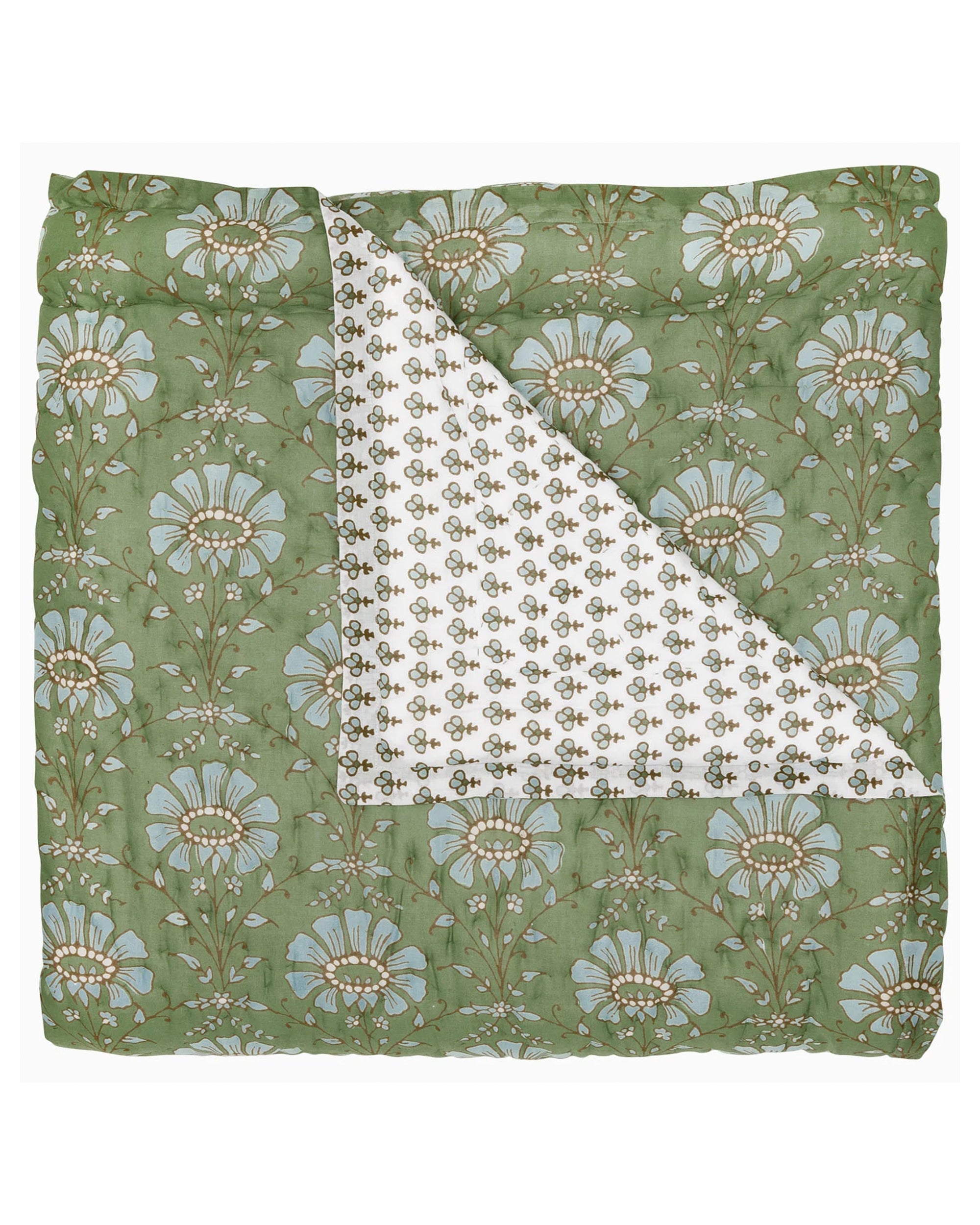 The Jeeva Sage Quilt by John Robshaw features a folded sage green design with bold blue florals, plus a white underside with a small leafy motif—an ideal choice for adding floral bedding charm to any space.