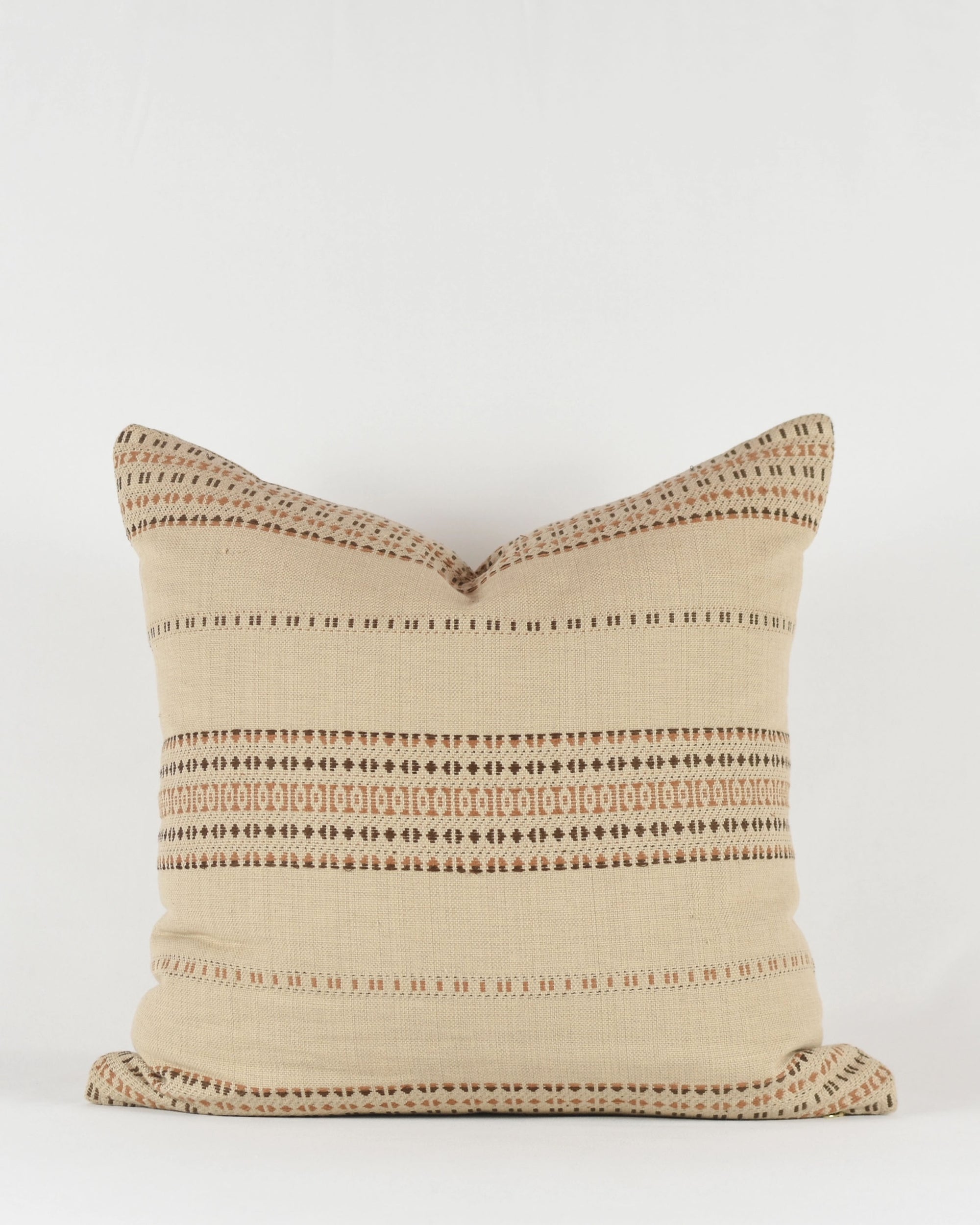 The Jacob Woven 22x22 Pillow by Faire features a square beige cotton cover handwoven in Gujarat, India, with brown and cream horizontal geometric patterns, shown against a plain white background.