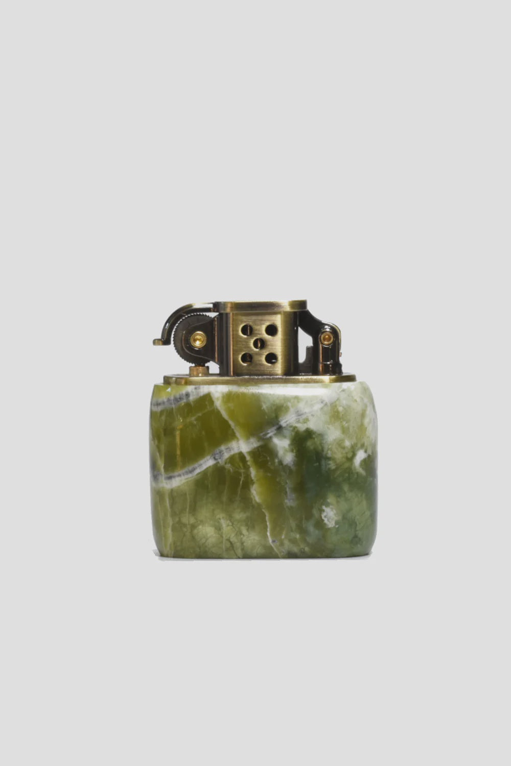 The MENS Kerosene Jade Lighter from Curated Basics features a green marbled stone base complemented by a solid brass top, highlighting intricate details and a circular hole pattern on its metal section.