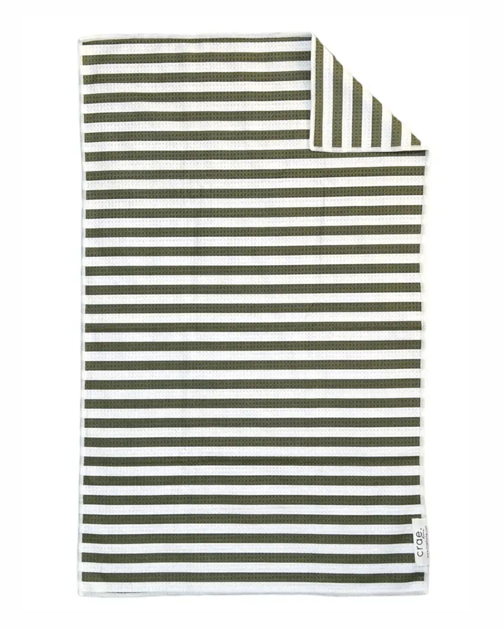 The Faire Hand Towel: Juniper is a rectangular waffle weave microfiber towel with horizontal dark green and white stripes. The top corner is folded to reveal vertical stripes on the reverse, and a small label appears in the bottom right corner.