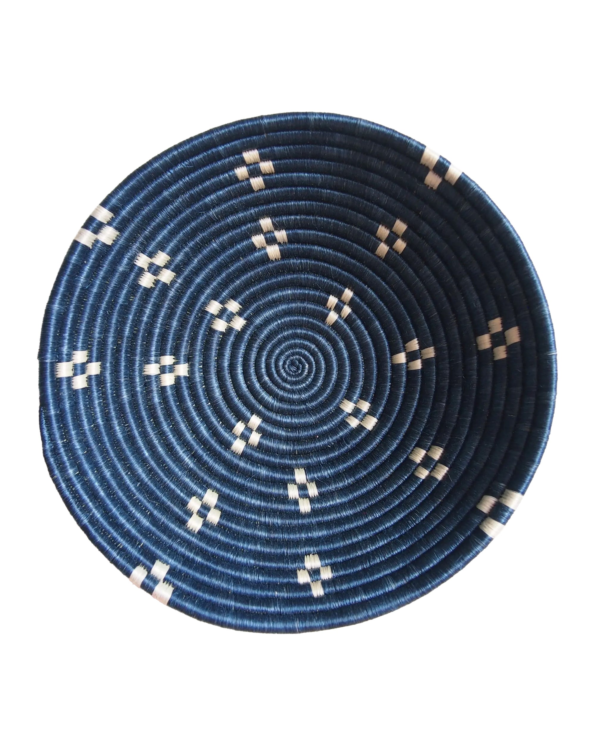 The Kabaya Large Bowl by Amsha - Faire is a round Rwandan basket featuring a dark blue spiral pattern with small white geometric designs evenly spaced around the sides, shown from above on a white background.