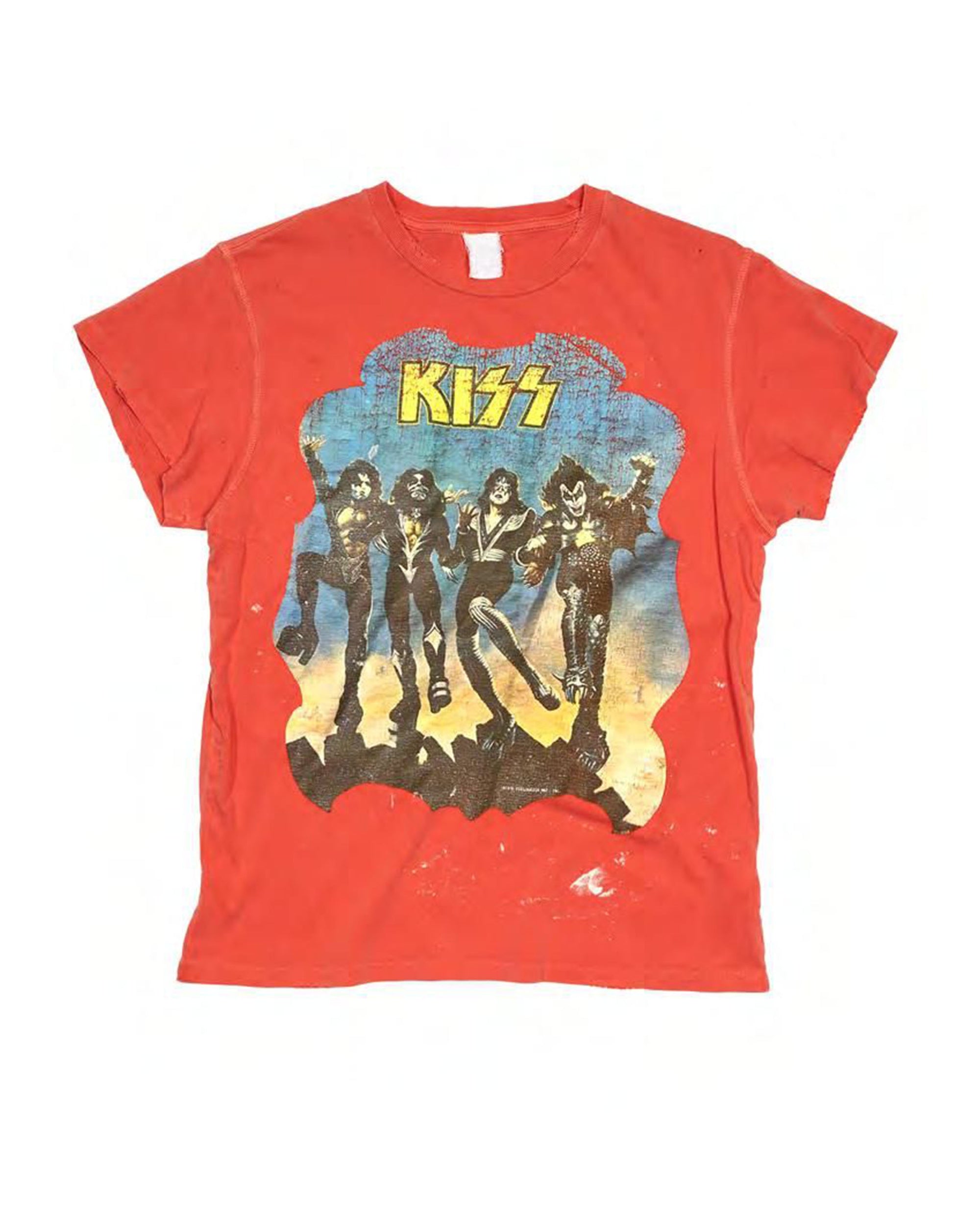 The Made Worn Kiss Tee is a red unisex crew shirt with a faded graphic of four band members in black costumes, the yellow "KISS" logo above them, and a blue-orange background.