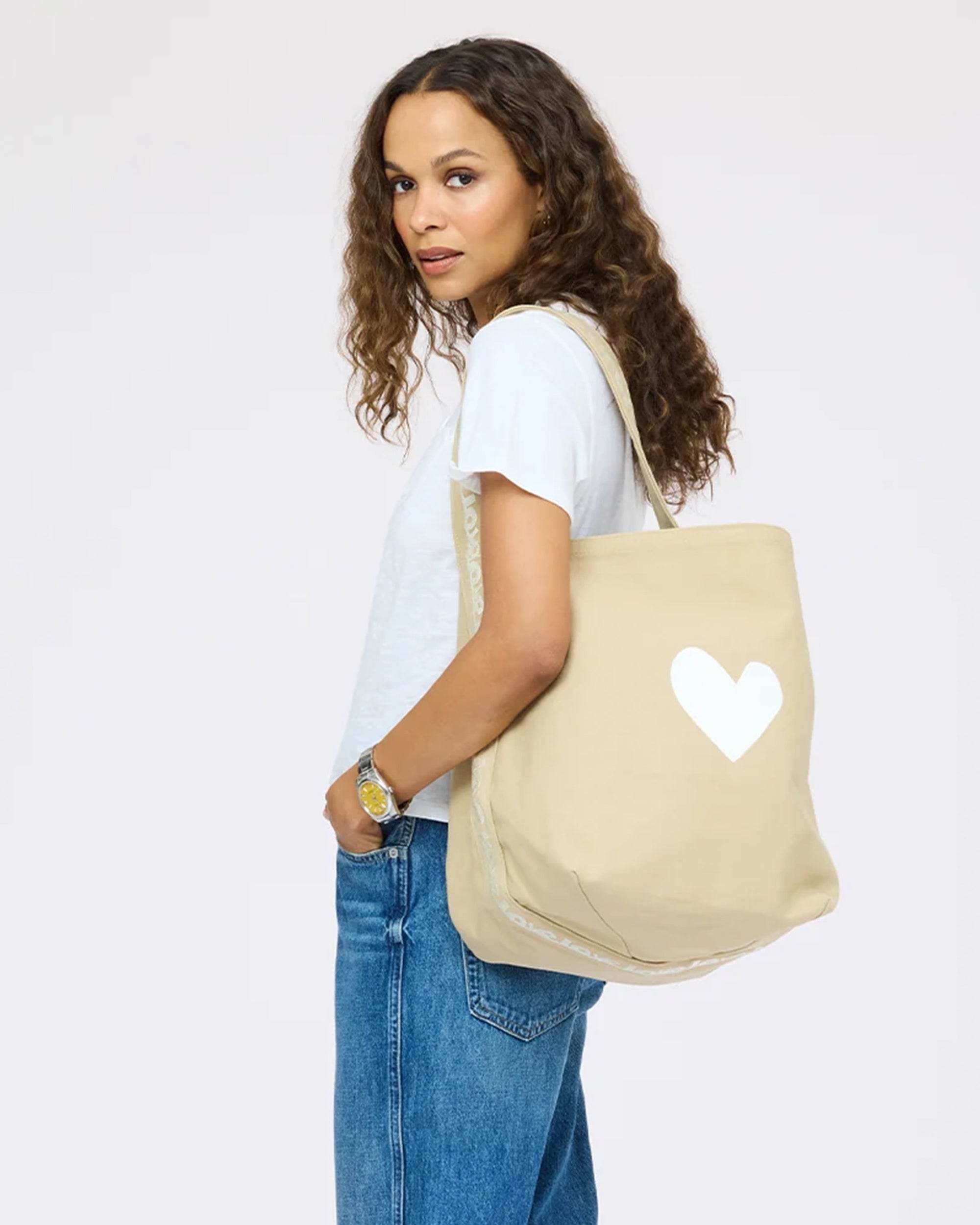 KR Imperfect Heart Hobo Tote by Kerri Rosenthal, carried by woman in casual white shirt and jeans, over-the-shoulder style.