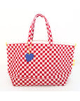 The KR Heart in Check Tote by Kerri Rosenthal showcases a red and white drippy hearts pattern on cotton canvas, two sturdy handles, and a blue heart charm, all set against a plain white background.