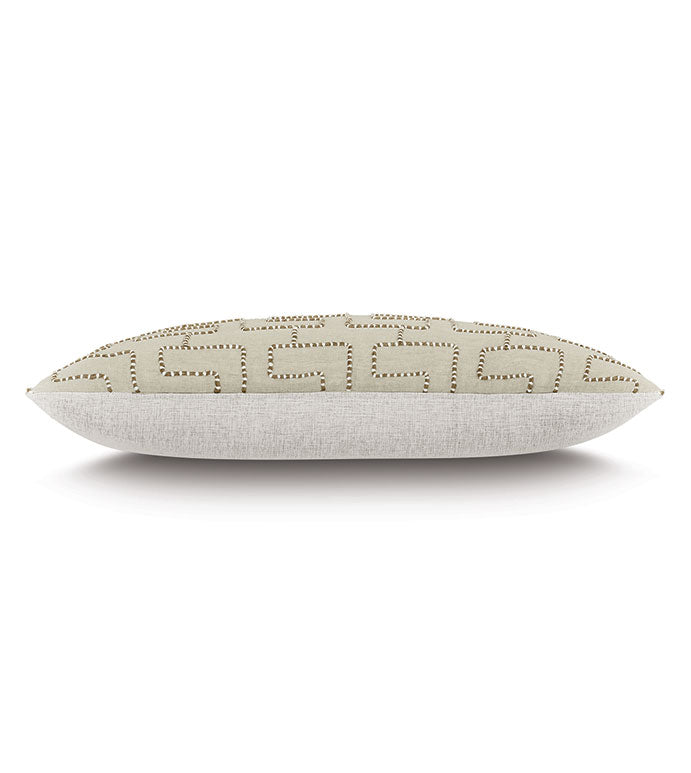The WREN JUTE by Eastern Accents is a rectangular beige throw pillow with a geometric metallic stud pattern, shown on its side against a white background.