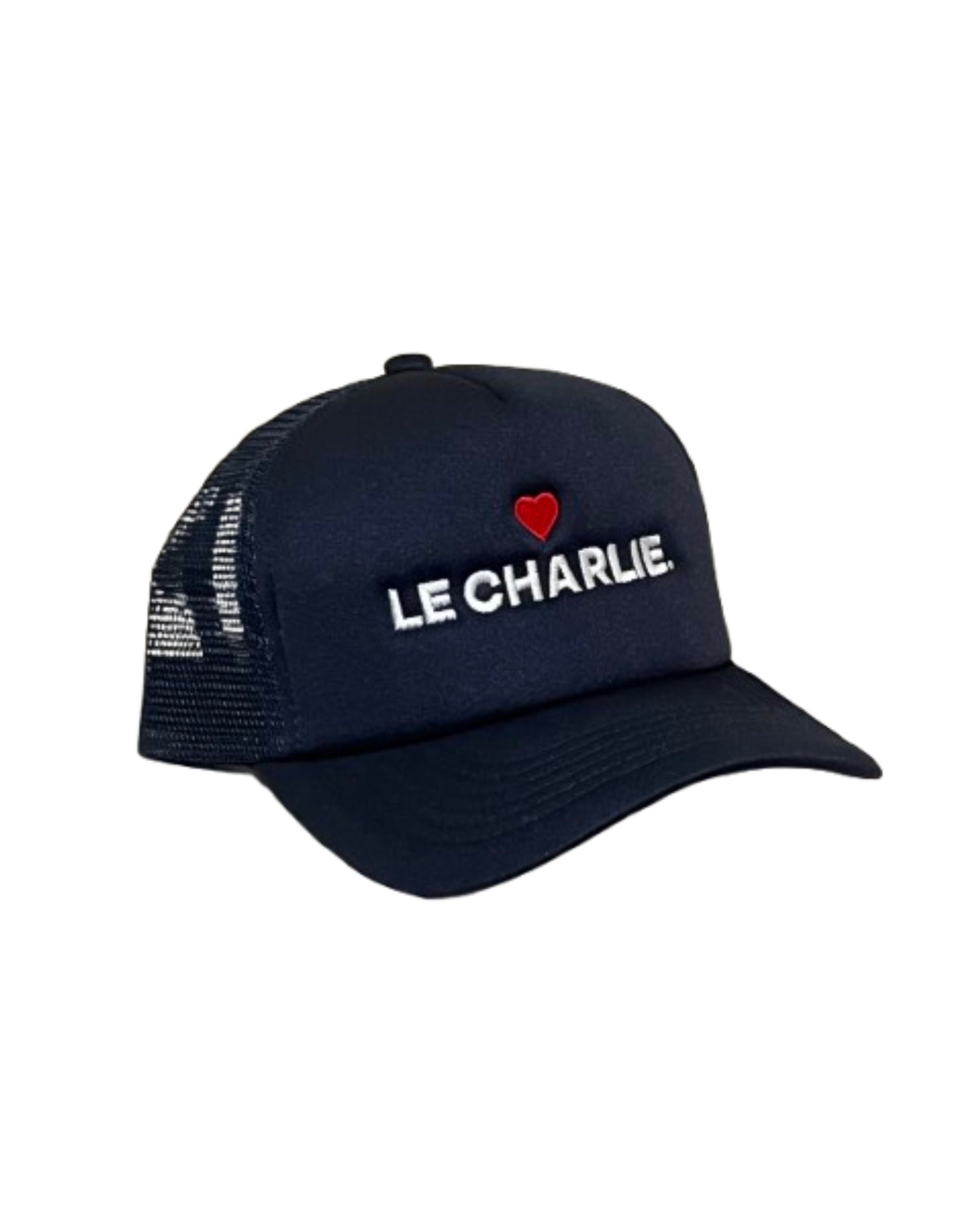 The Le Charlie Hat by Ping Pong Surf Club is a black foam trucker cap with mesh sides, displaying "LE CHARLIE." in white and a small red heart above the text on the front panel.