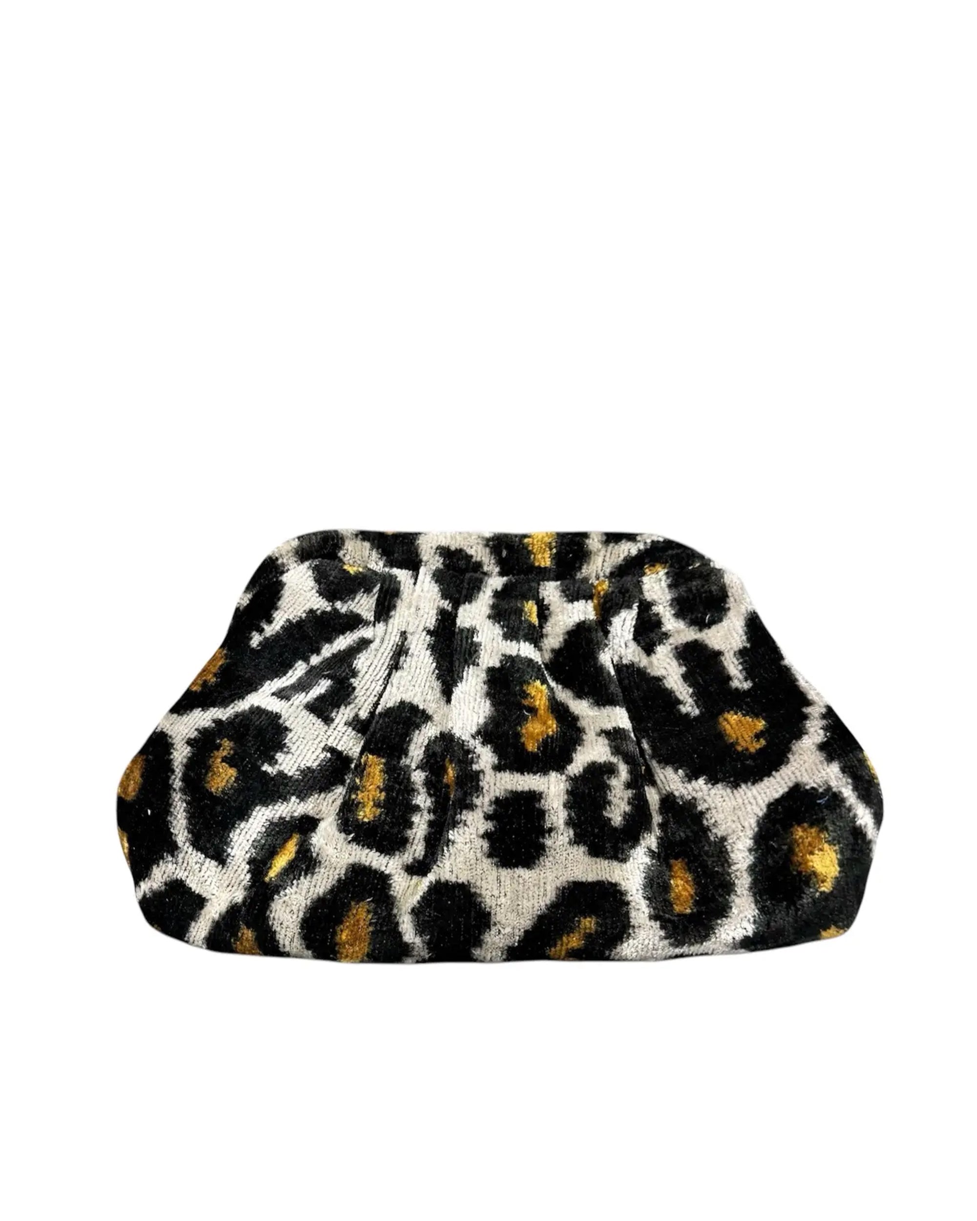 The Faire Silk Velvet Ikat Soft Clutch is a hand-woven purse featuring a bold black, white, and yellow leopard print, displayed against a plain white background.