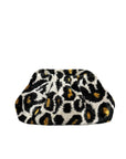 The Faire Silk Velvet Ikat Soft Clutch is a hand-woven purse featuring a bold black, white, and yellow leopard print, displayed against a plain white background.