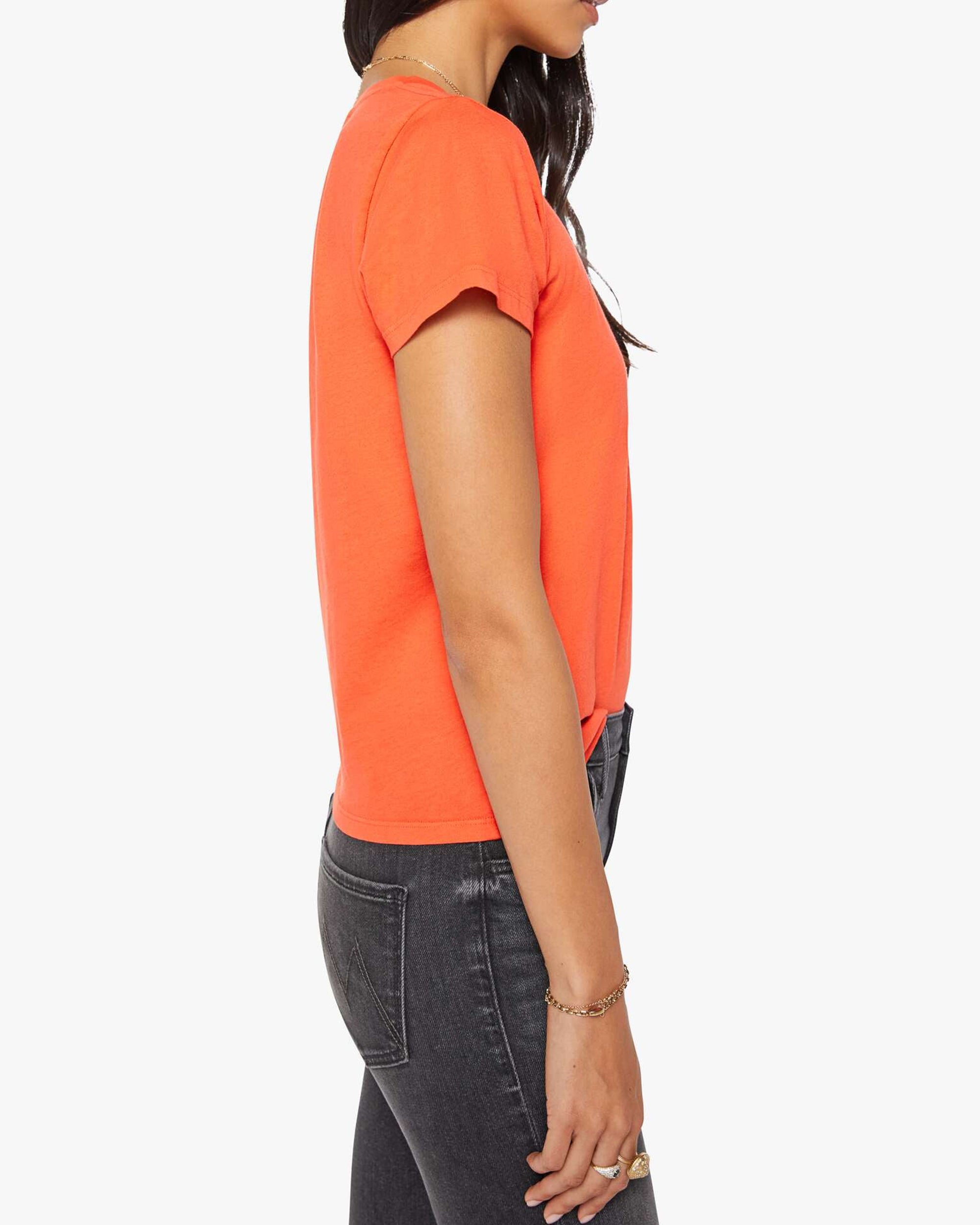 Black jeans and The Lil Goodie Goodie Tee by Mother styled for a retro look, model posed against white backdrop.