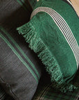 Libeco Home Nell flax linen pillows with chic stripes and fringe on a plaid pattern, perfect for modern living rooms.