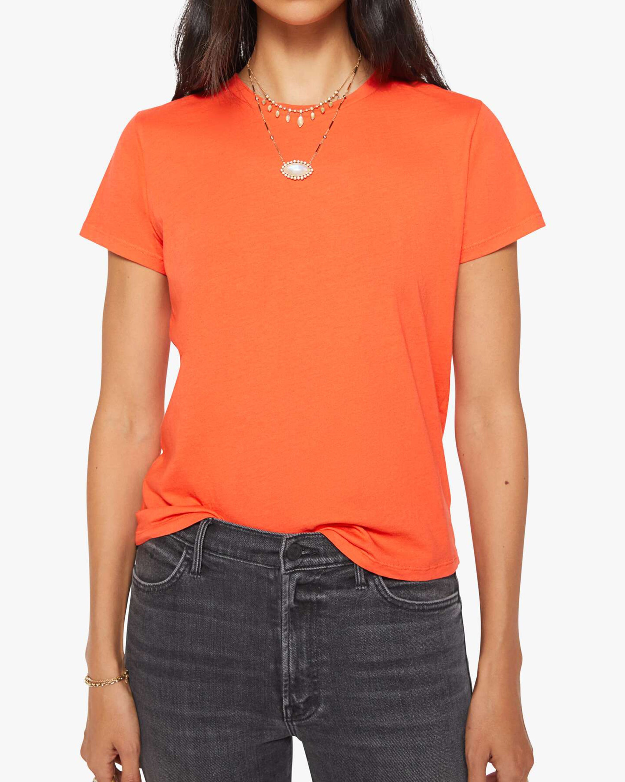 Mandarin red Mother’s The Lil Goodie Goodie Tee styled with layered necklaces and black jeans, front view.