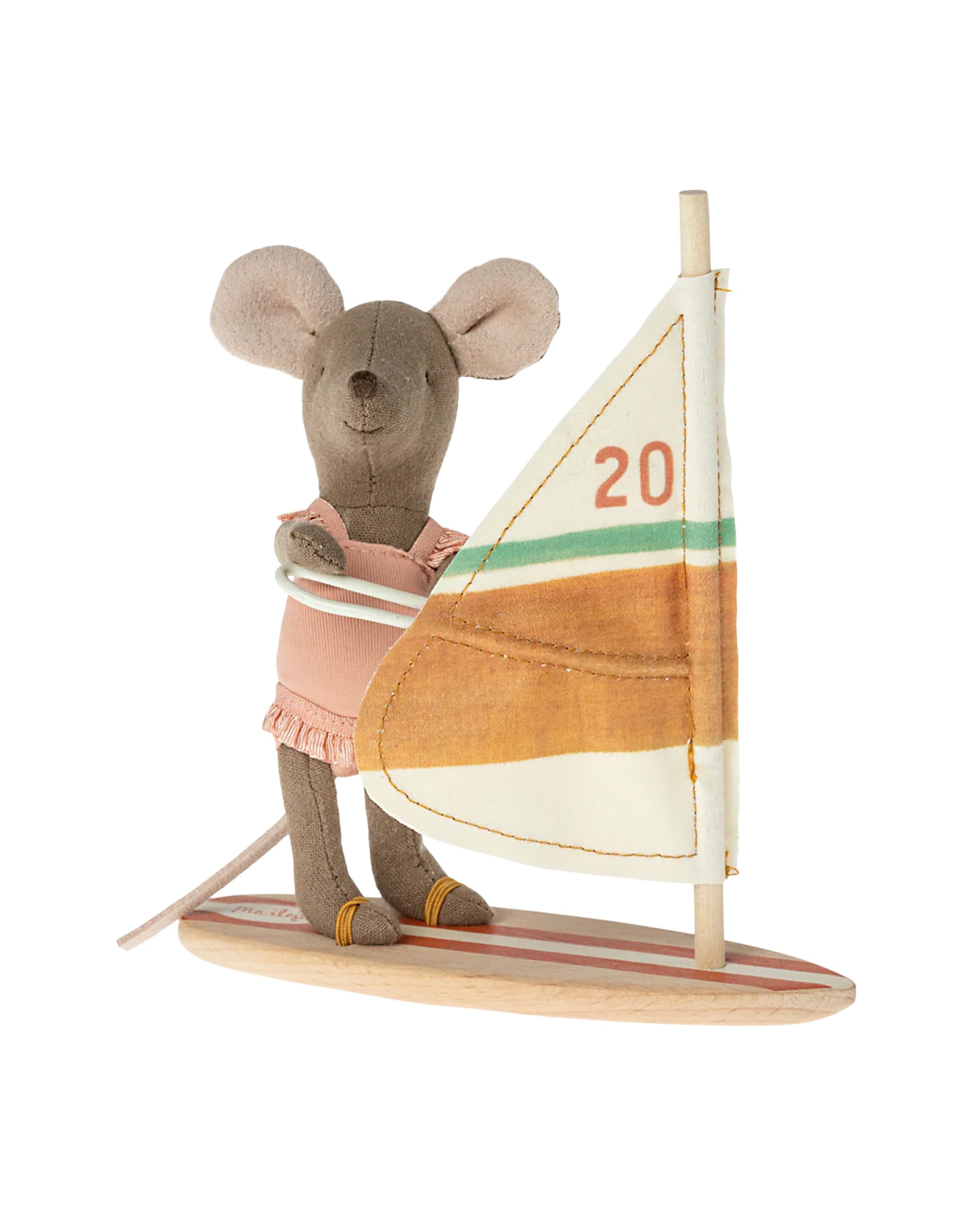 The Maileg Little Sister Beach Surfer by Maileg is a plush mouse toy dressed in a ruffled one-piece, standing on a striped wooden surfboard with an orange and green sail featuring the number "20"—perfect for imaginative play.