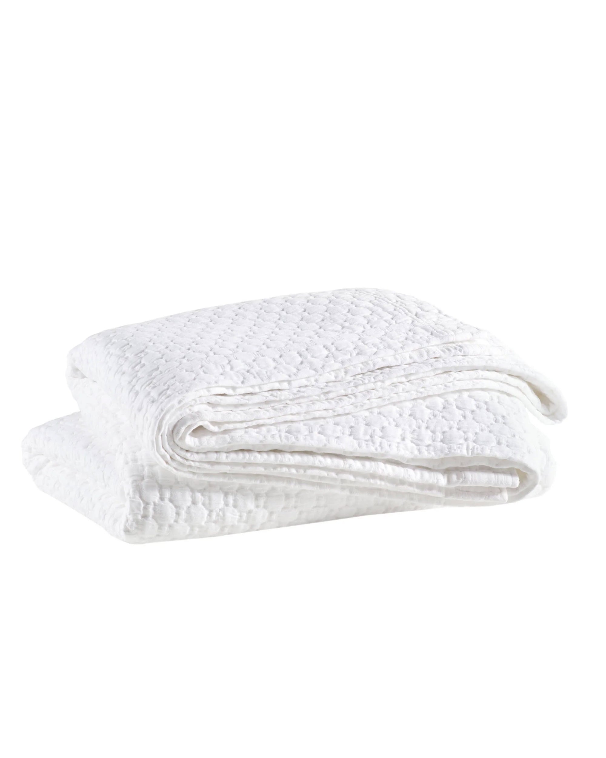 The Pinecone Hill Lodi Matelasse Coverlet, a neatly folded white cotton layer with a subtle diamond pattern, is displayed on a plain white background.