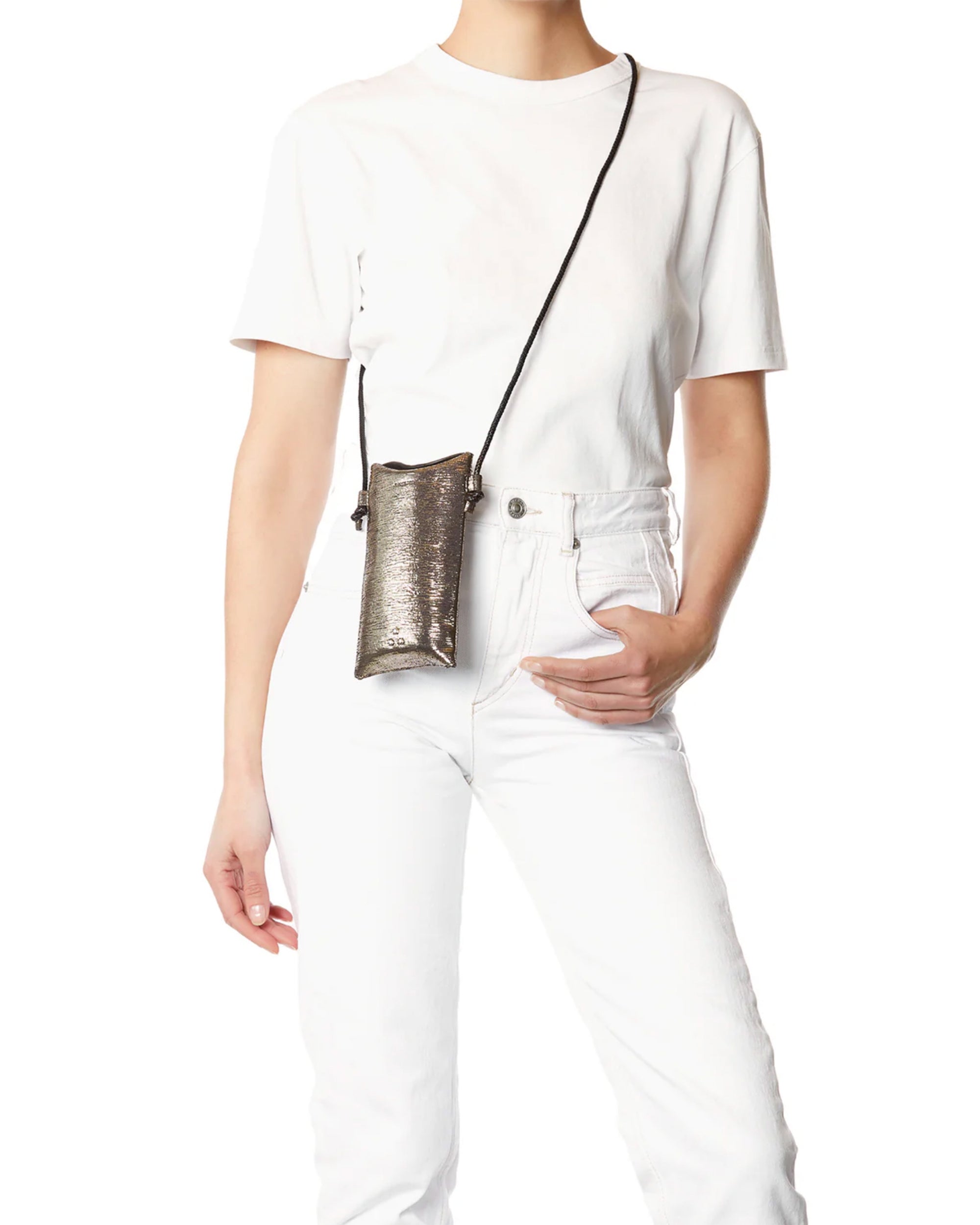 Wearing a plain white t-shirt and white jeans, a person stands with one hand in their pocket, modeling the Jerome Dreyfuss Louis Mobile Holder—a small metallic crossbody bag with an adjustable shoulder strap.
