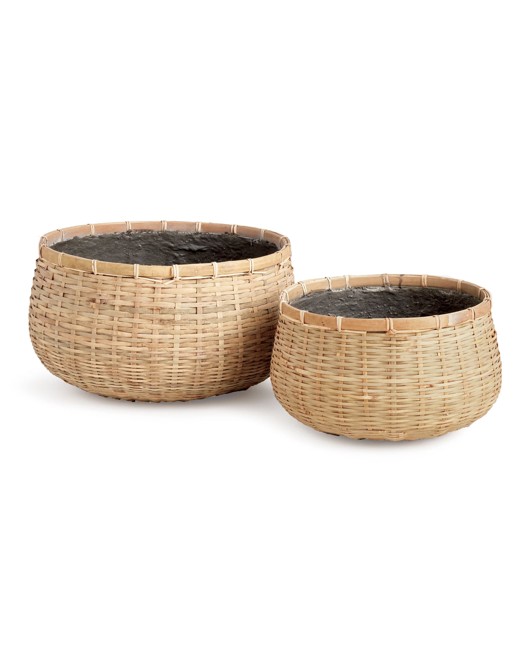 The Wovenshire Low Bowl L by Napa Home & Garden is a large, round woven rattan basket lined with black plastic. Its natural bamboo color and rustic design make it versatile for storage or décor in any space.