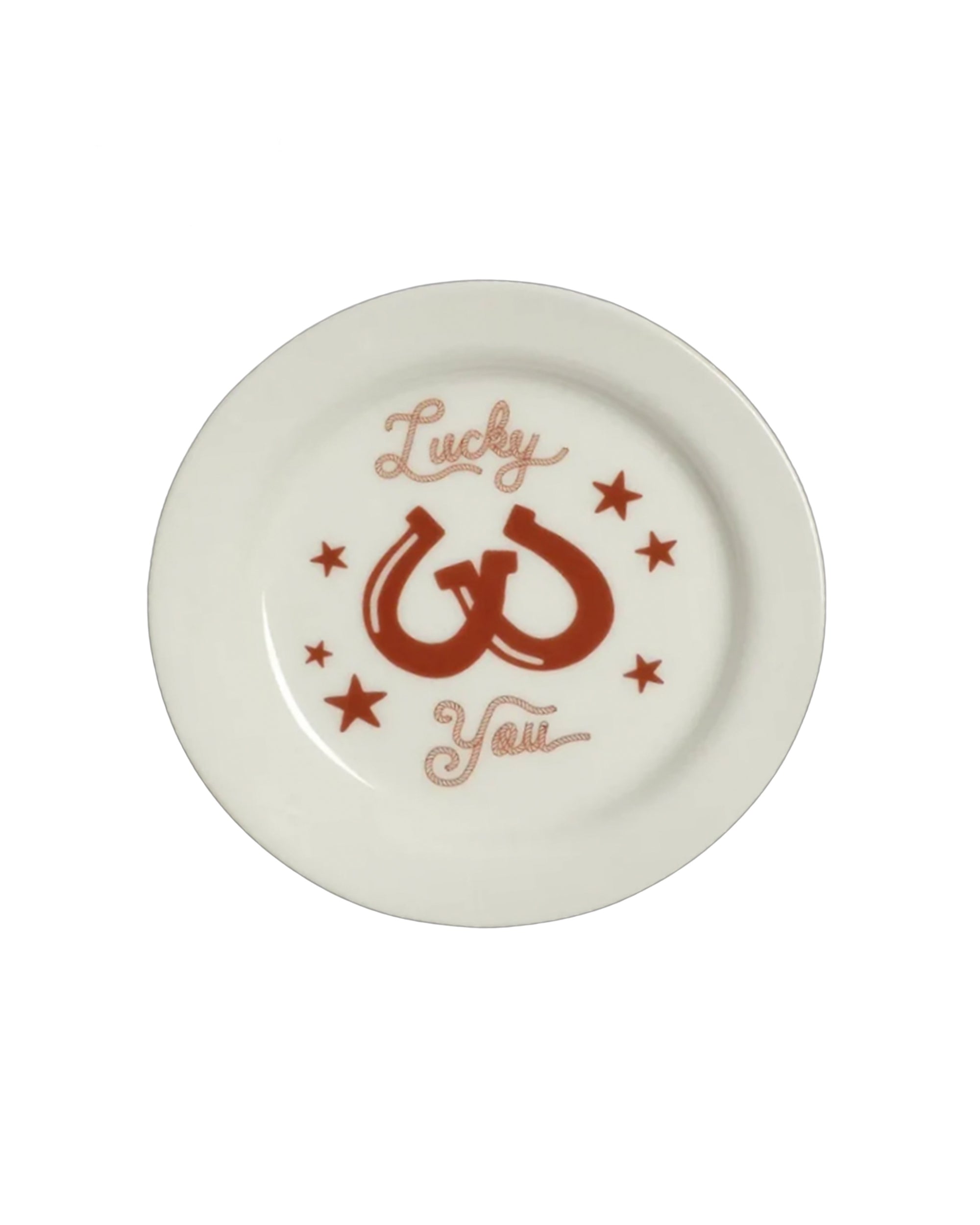 Round white plate with red horseshoes and stars, Lucky You script at center, by Fishs Eddy for Bungalow Furniture.