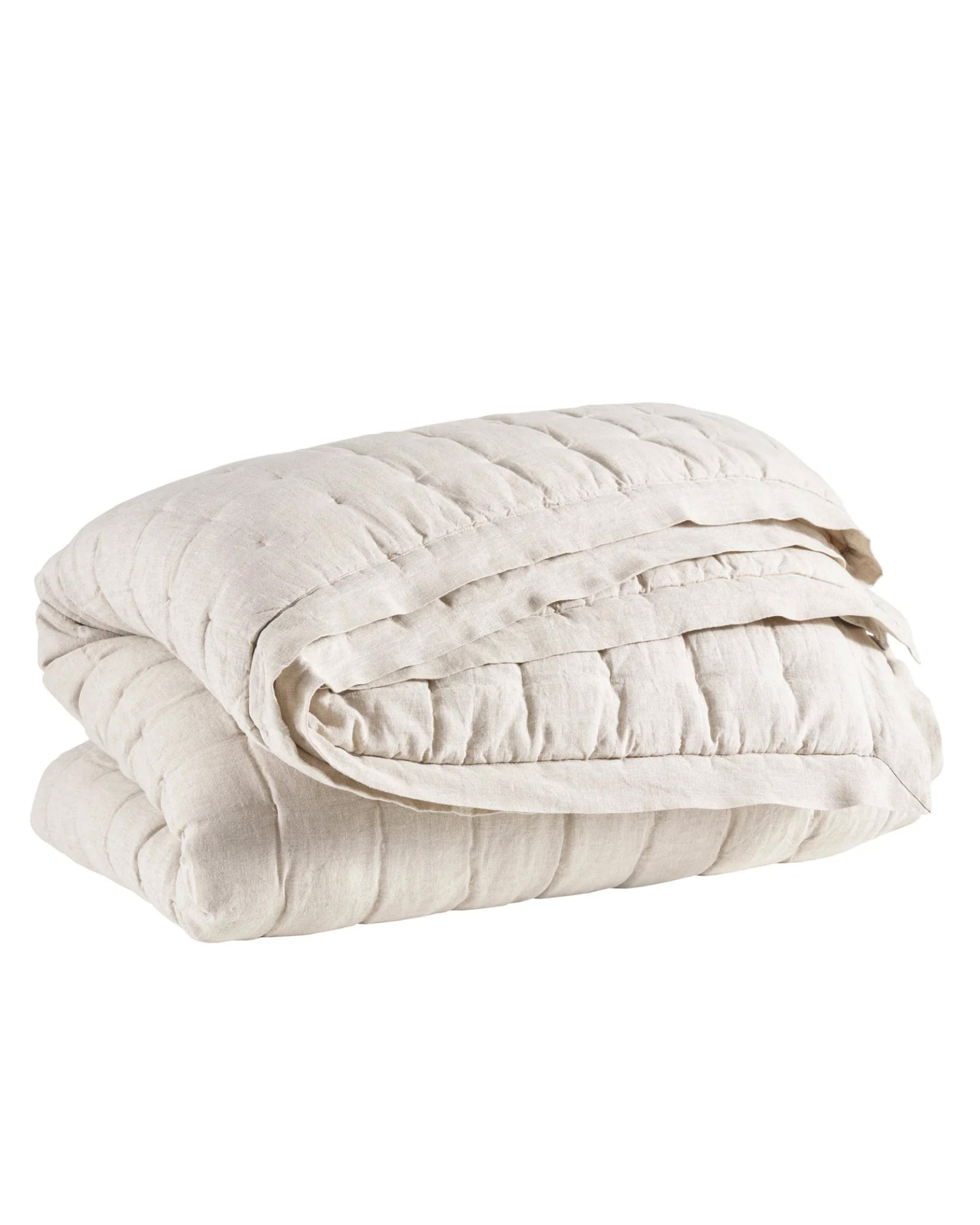 The Pinecone Hill Lush Linen Puff Twin is a light beige quilted blanket with visible stitching, neatly folded and showcased against a plain white background—a cozy addition to any room.