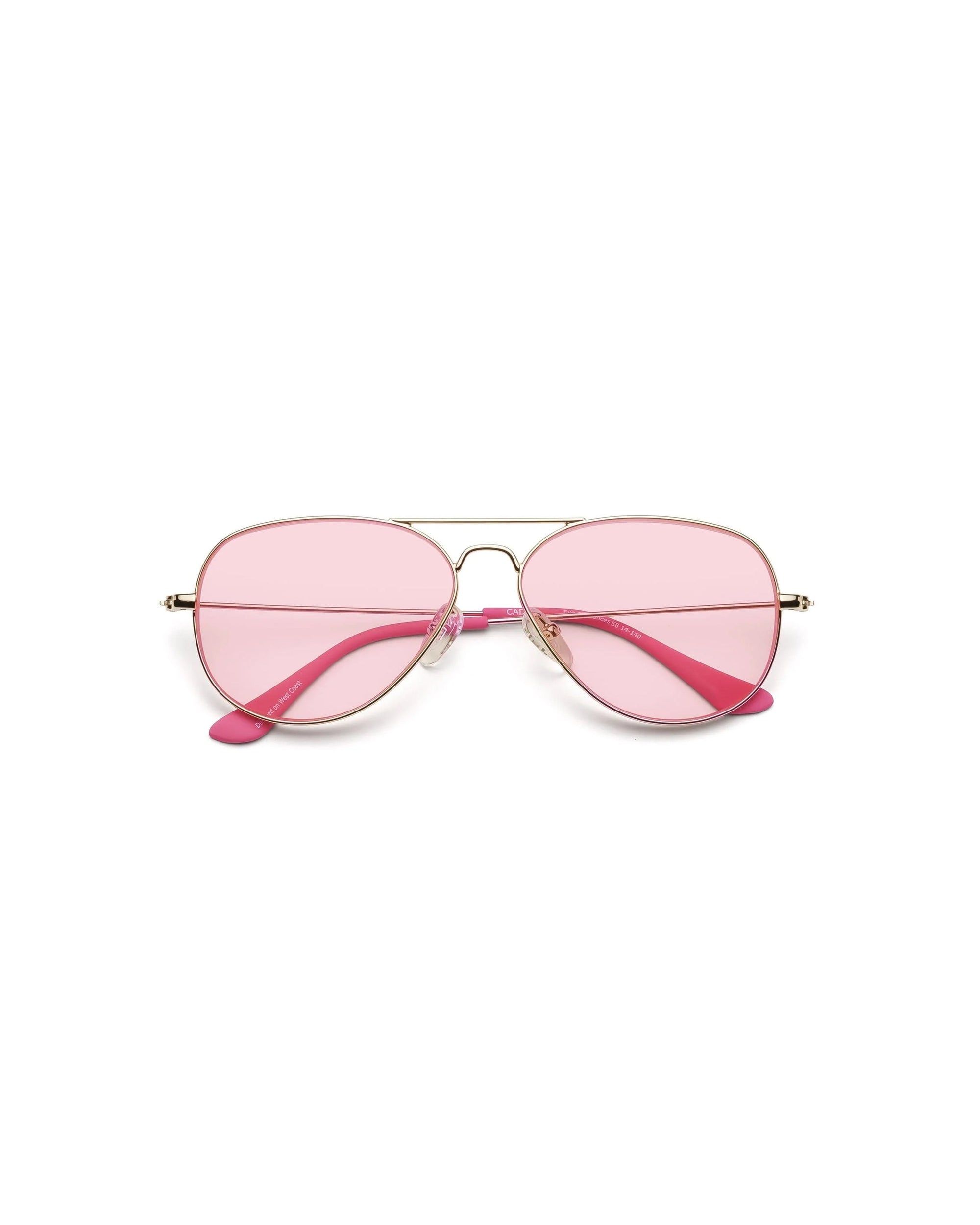 The Caddis Mabuhay Polished Gold features wire frame aviator sunglasses with thin gold metal frames, pink-tinted lenses, and comfortable rubber temple tips, shown on a white background.