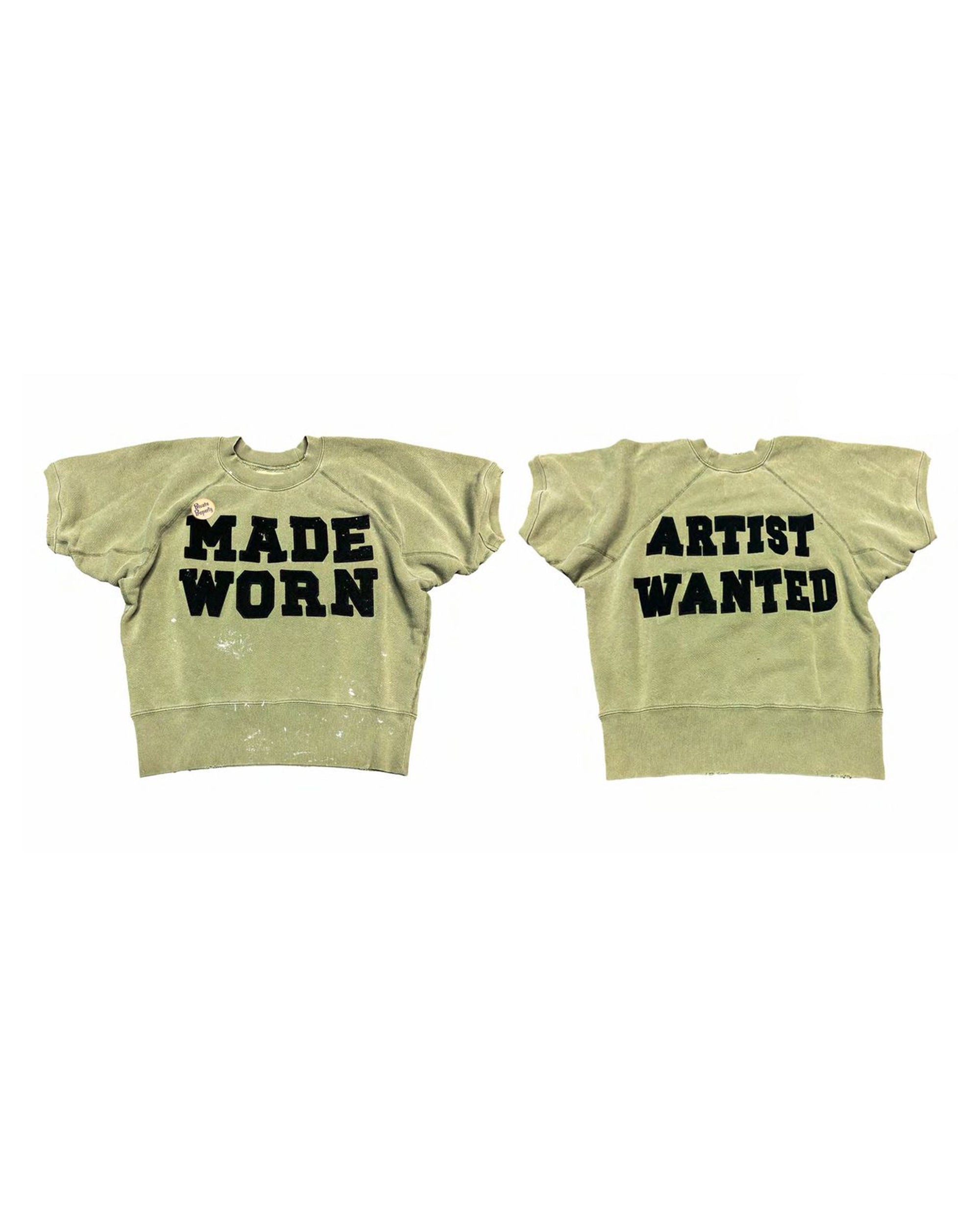 The Made Worn Artist Wanted Shrunken SS Sweatshirt in Fatigue features bold "MADE WORN" text on the front, "ARTIST WANTED" on the back, a slightly worn look, and paint splatters. Shown from both front and back.