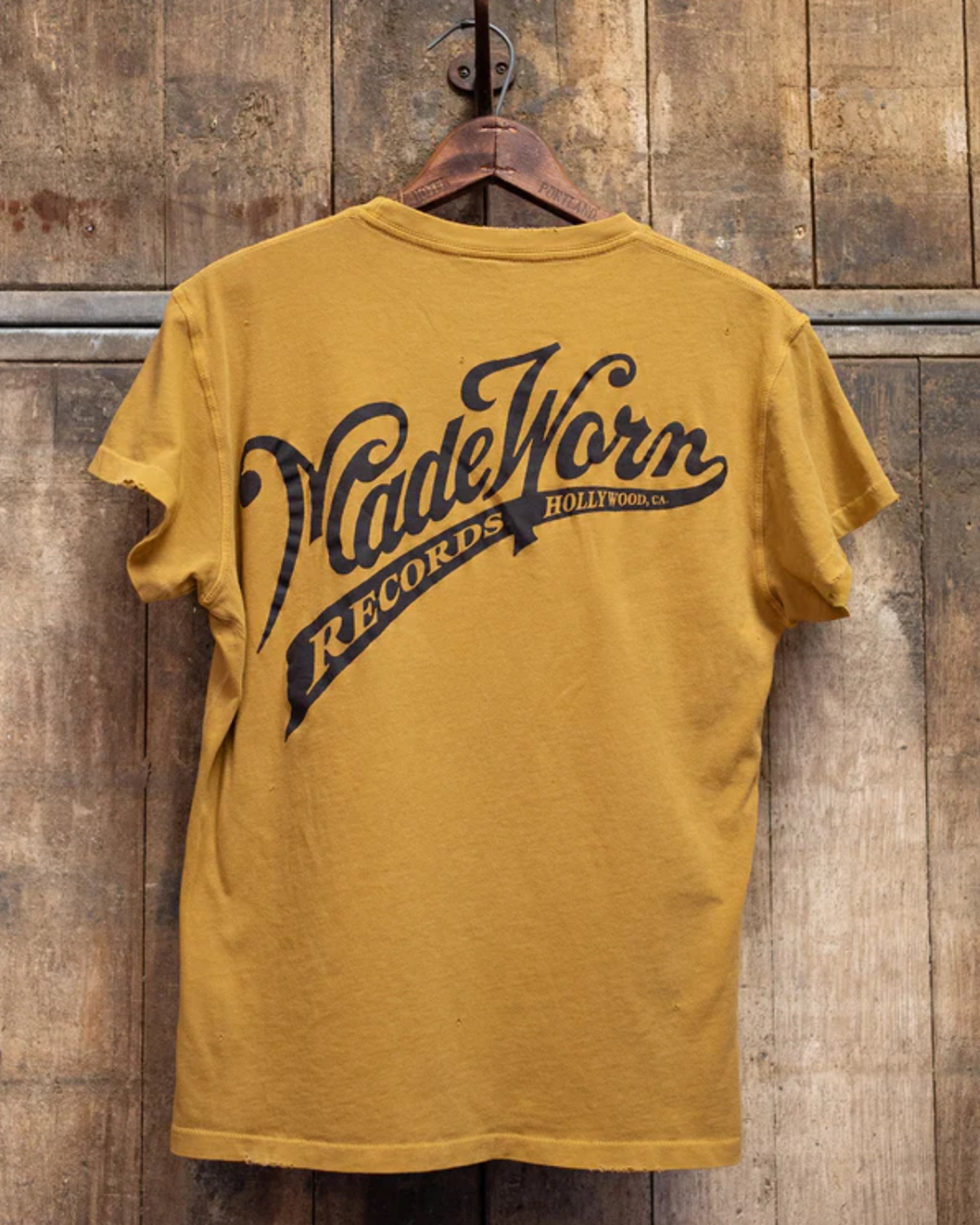 The Made Worn Pocket Tee MadeWorn Records is a mustard yellow, vintage unisex 100% cotton shirt with a back print that says "MadeWorn RECORDS HOLLYWOOD, CA." Proudly made in the USA.
