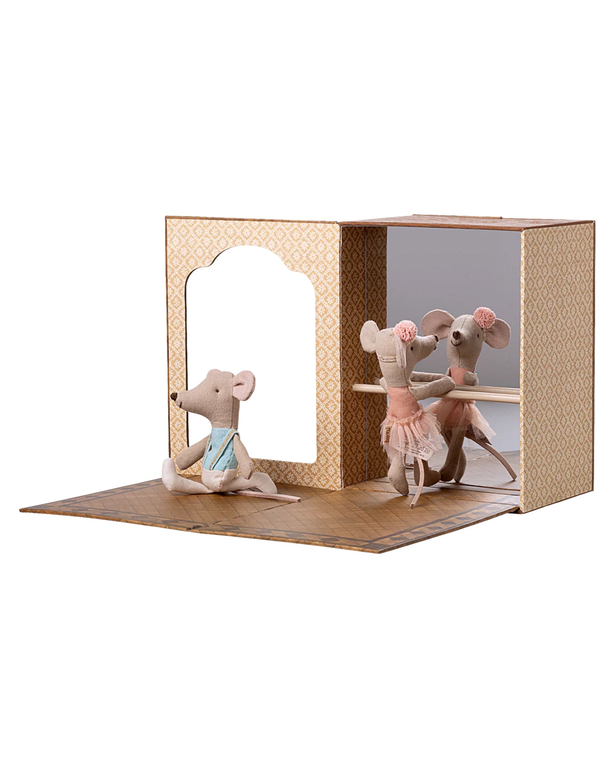 The Maileg Ballet Mice / Little Sis & Bro by Maileg features three ballet mice in a cardboard ballet playset, with one in a blue top sitting and two in pink tutus standing at the barre, reflected in a studio mirror.