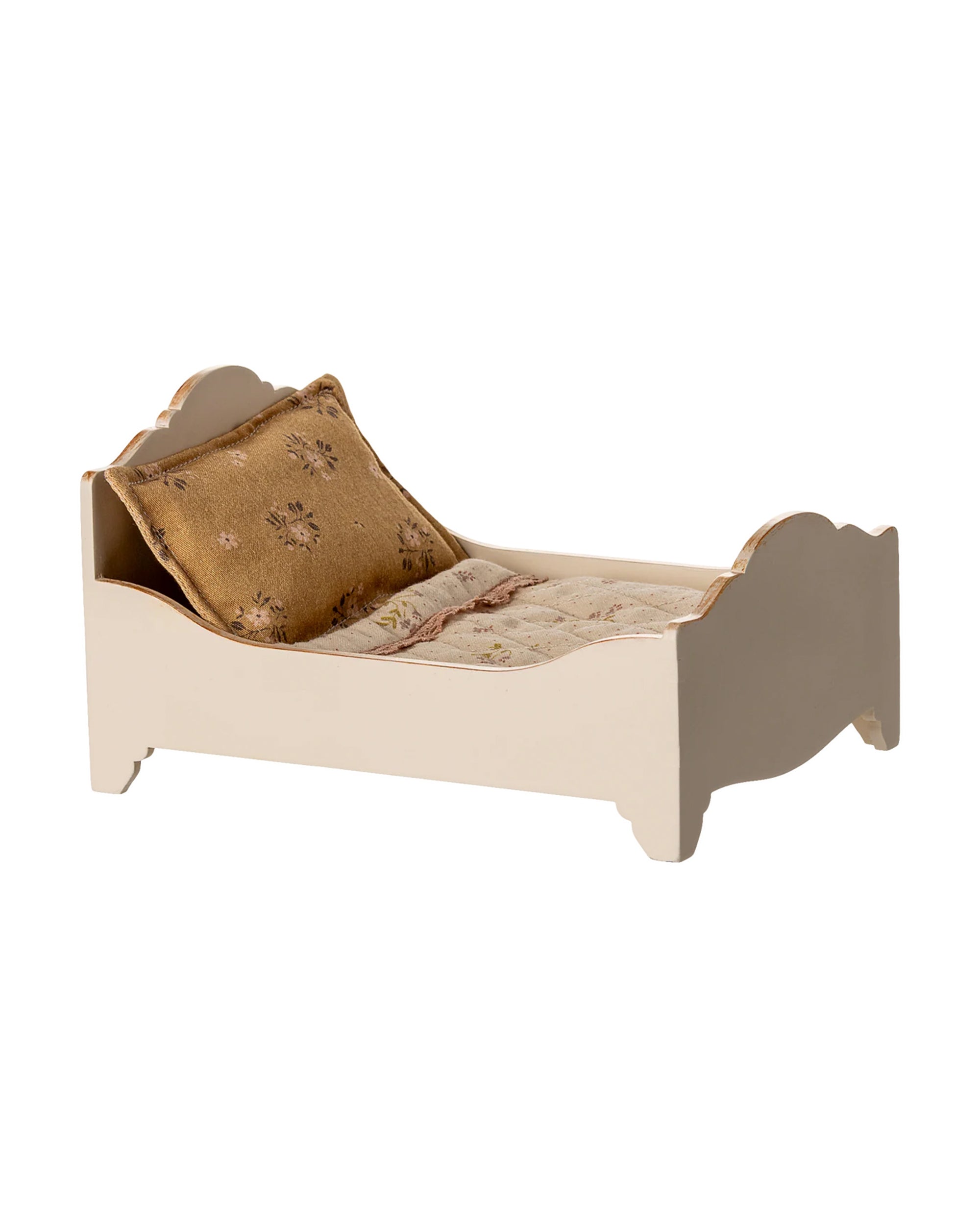 The Maileg Bed by Maileg is a small, cream-colored doll bed with ornate gold-finished headboard and footboard, plus a patterned pillow and matching beige blanket—ideal as a charming bed for mice.