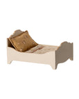 The Maileg Bed by Maileg is a small, cream-colored doll bed with ornate gold-finished headboard and footboard, plus a patterned pillow and matching beige blanket—ideal as a charming bed for mice.