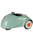 Light green vintage metal toy car with whitewall tires and black steering wheel by Maileg.