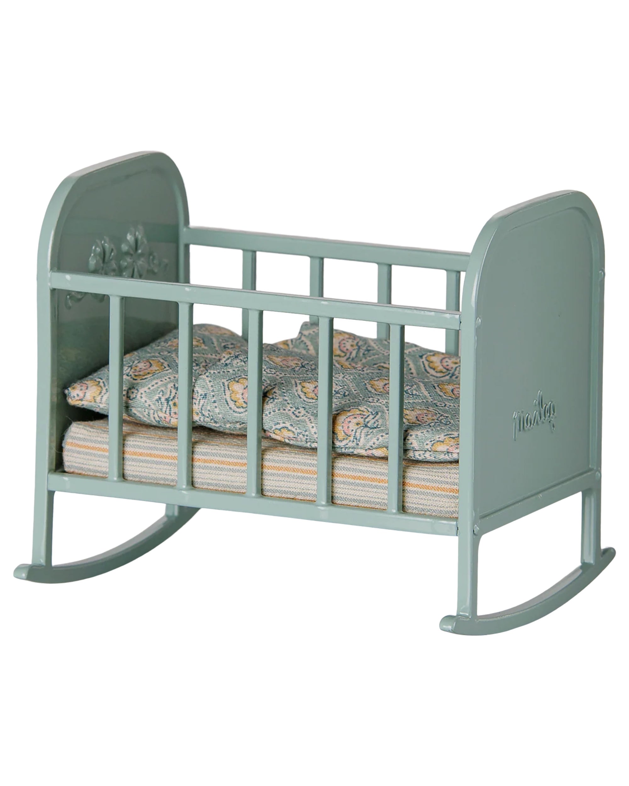 Small green Maileg metal cradle with patterned mattress and pillow, perfect for toy rabbits.