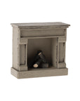 The Maileg Fireplace by Maileg is a small, decorative wooden miniature with a vintage finish and three faux logs—ideal as a cozy accent for any mouse home.