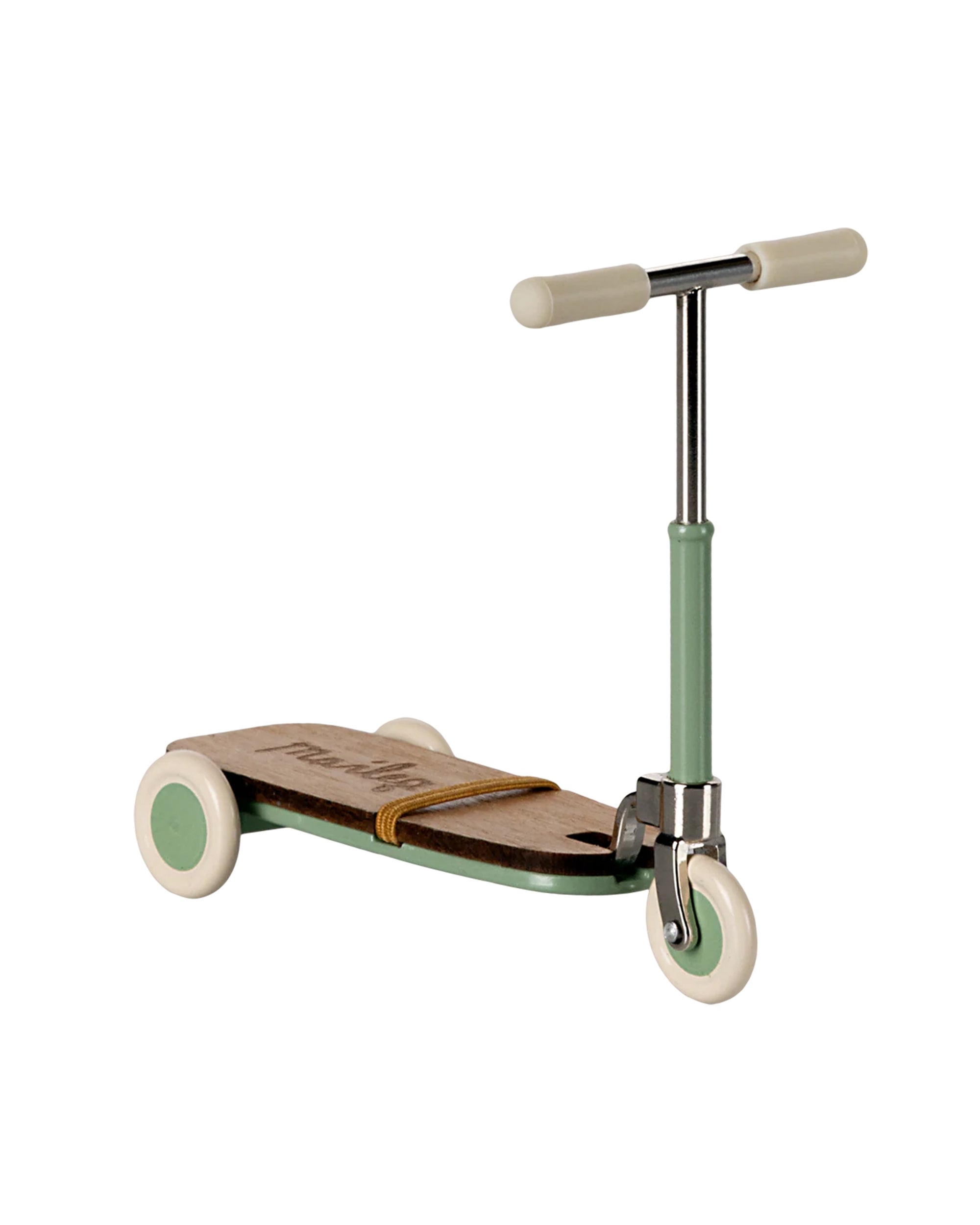 The Maileg Kick Board by Maileg is a children's scooter with a wooden deck, light green handlebar and wheels, plus white accents, displayed against a plain white background.