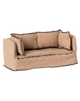 The Maileg Couch, Miniature by Maileg is a small tan fabric sofa with two seat cushions, three back cushions, and dark trim—ideal as dollhouse furniture or a charming accent for your miniature collection.
