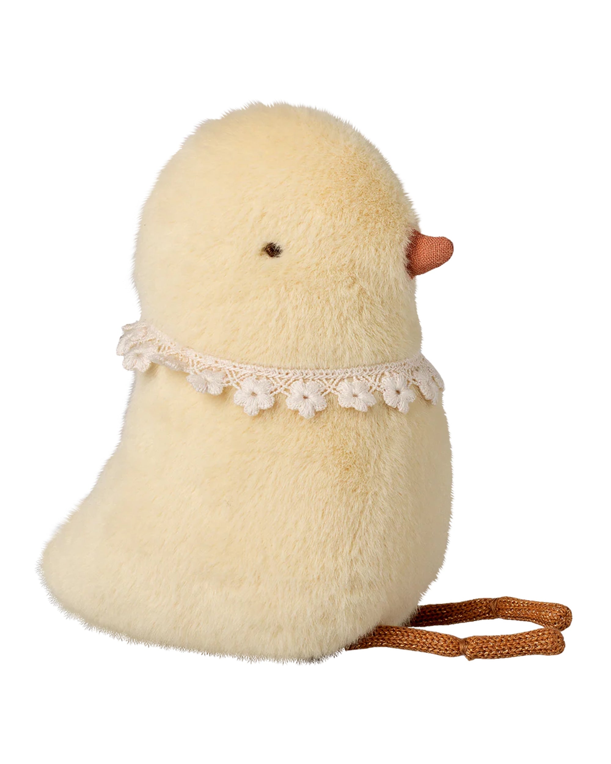 The Maileg Chicken Plush, Small features fluffy yellow fur, a lace flower collar, and a brown string. Soft to the touch with black eyes and an orange beak. Shown on a white background.