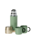The Maileg Thermos & Cups set by Maileg features a green thermos with a gold cap and two green mugs with black handles—ideal for refreshment on the go, whether for hiker mice or anyone who loves adventure.