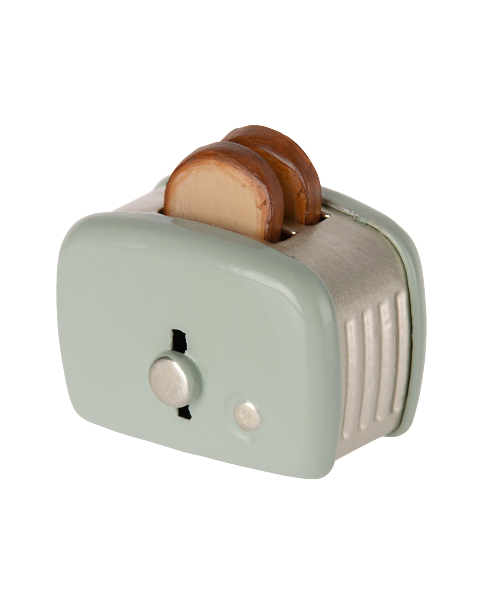 The Maileg Toaster by Maileg is a small, pale green metal toaster with two slices of toast inside, featuring a button and dial design—perfect for any Mouse Hole Farmhouse playset.