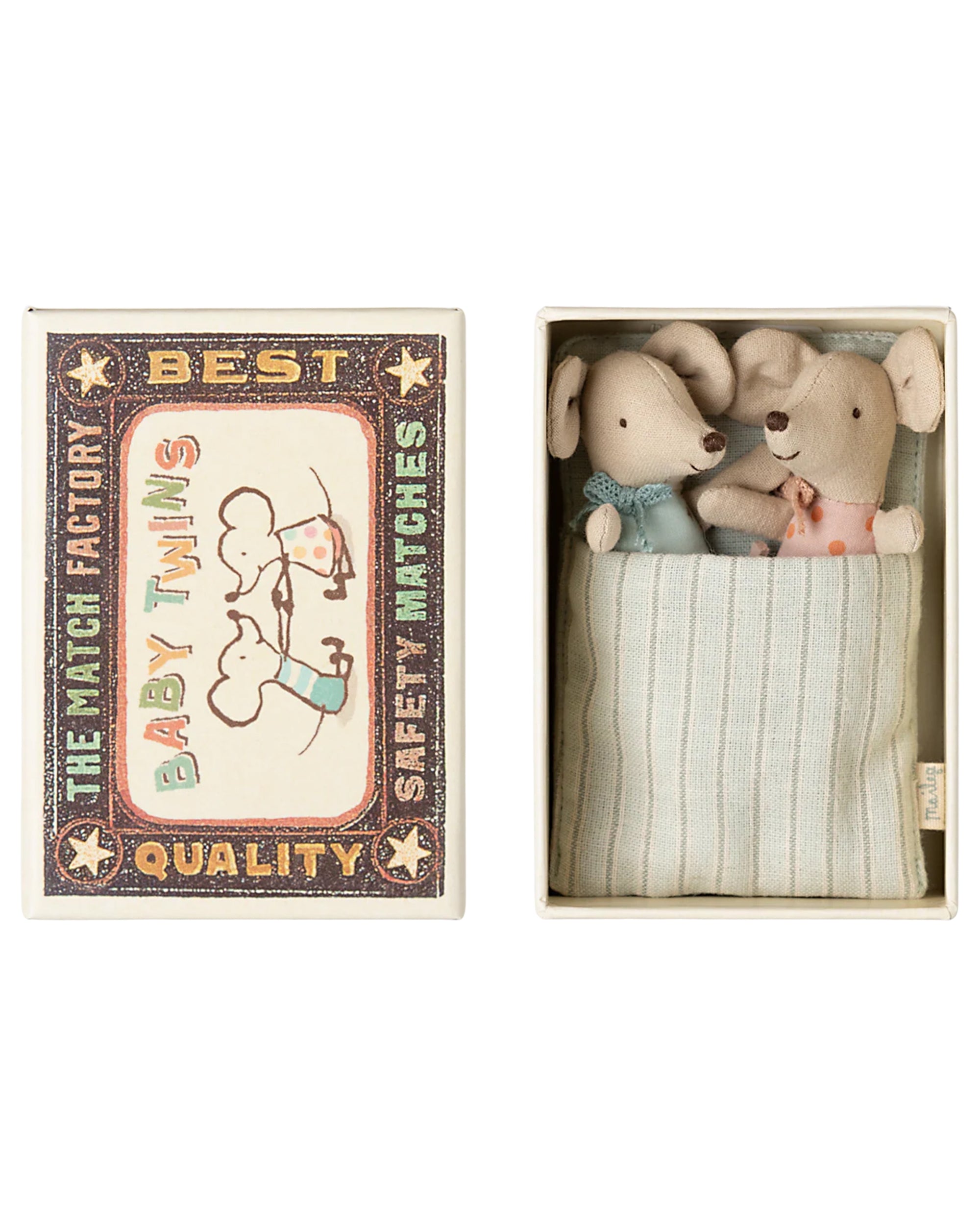 Maileg Baby Twins Matchbox by Maileg features two small baby mice in blue and pink outfits, cozily wrapped in a striped blanket inside a matchbox bed with "The Match Factory Best Quality Baby Twins Safety Matches" and twin mouse artwork on the lid.