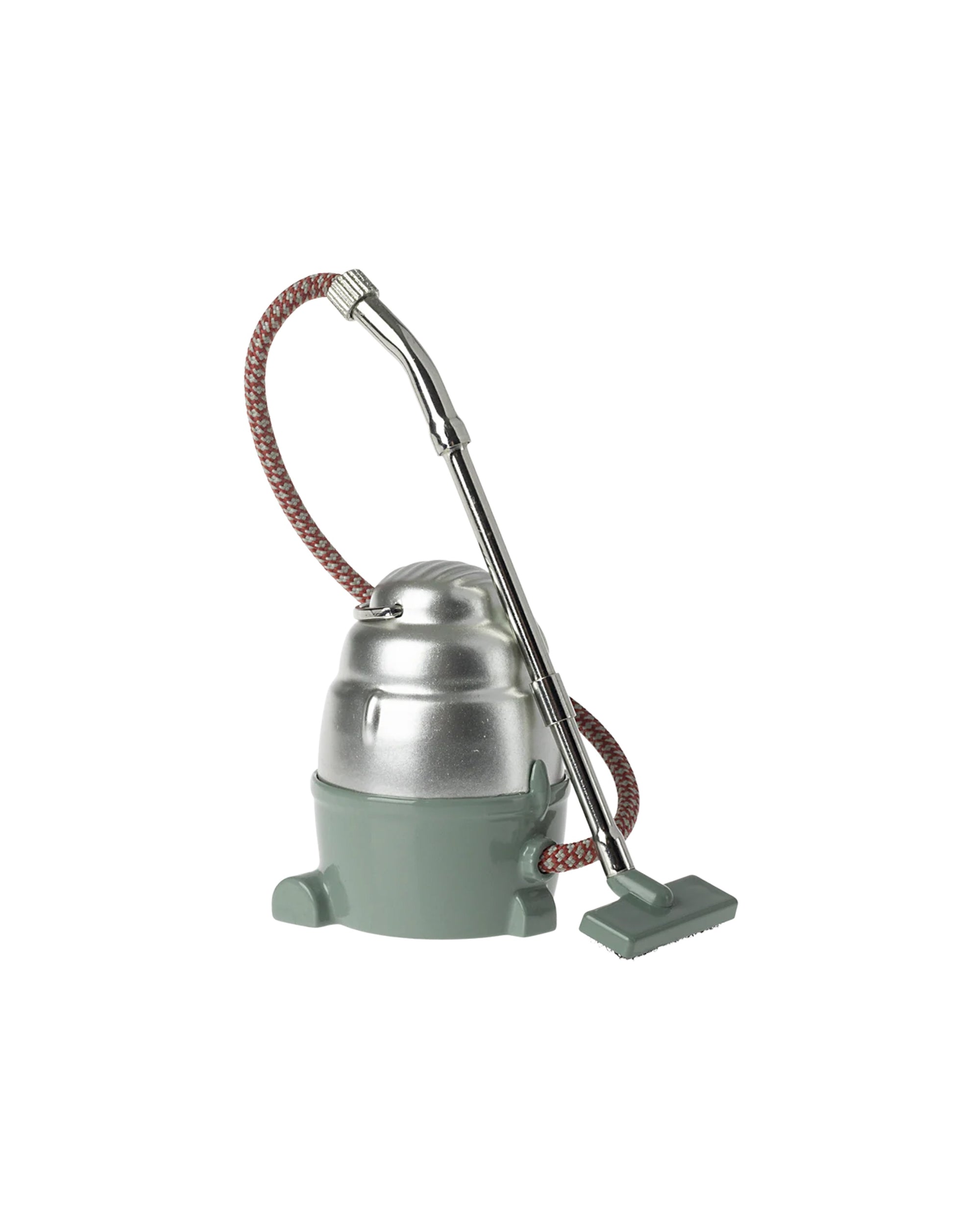 The Maileg Vacuum Cleaner by Maileg features a vintage silver metal body, green base, braided hose, and a green rectangular floor nozzle—ideal for effortless cleaning. Shown against a plain white background.